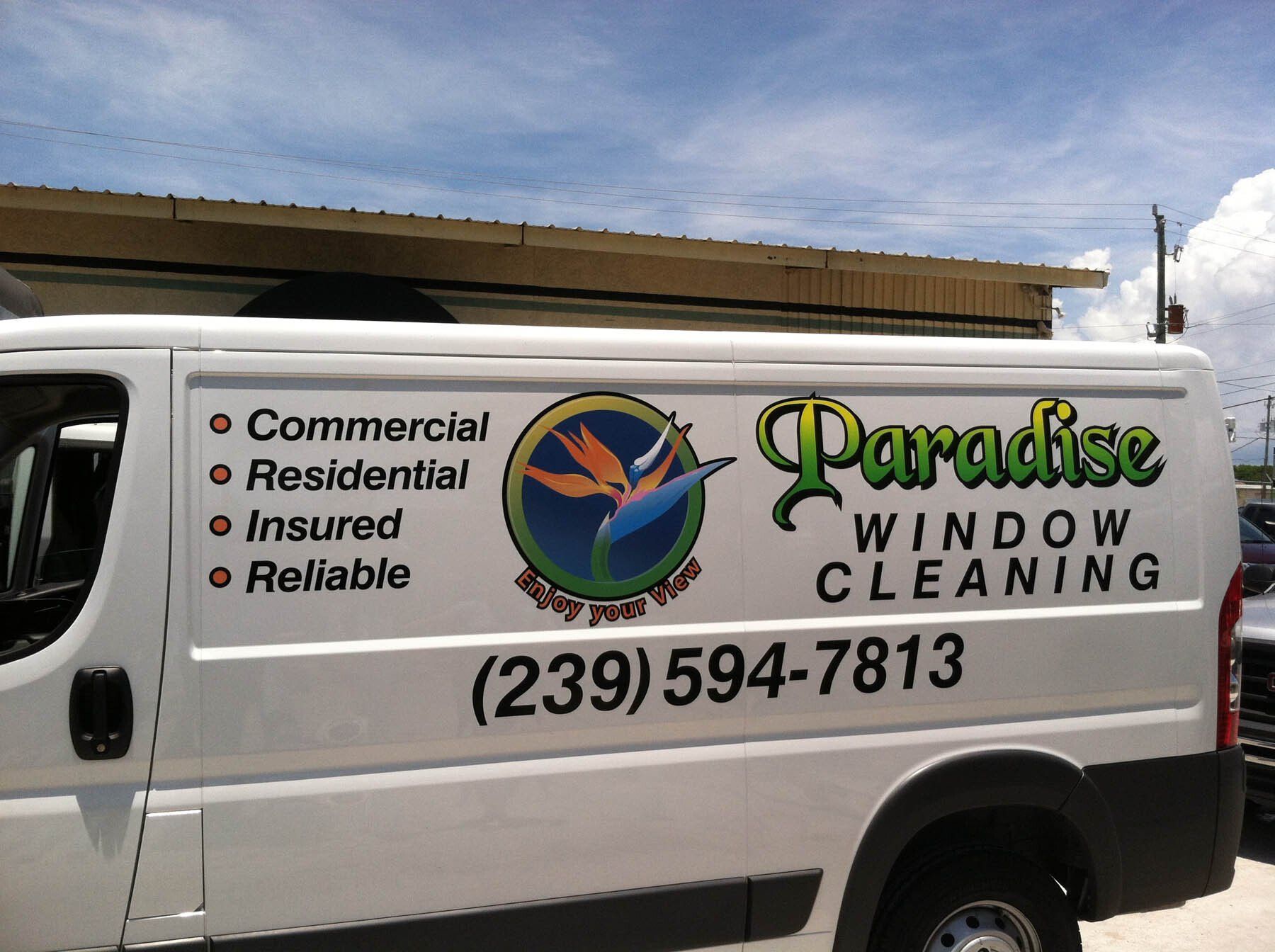 A white van that says paradise window cleaning on the side