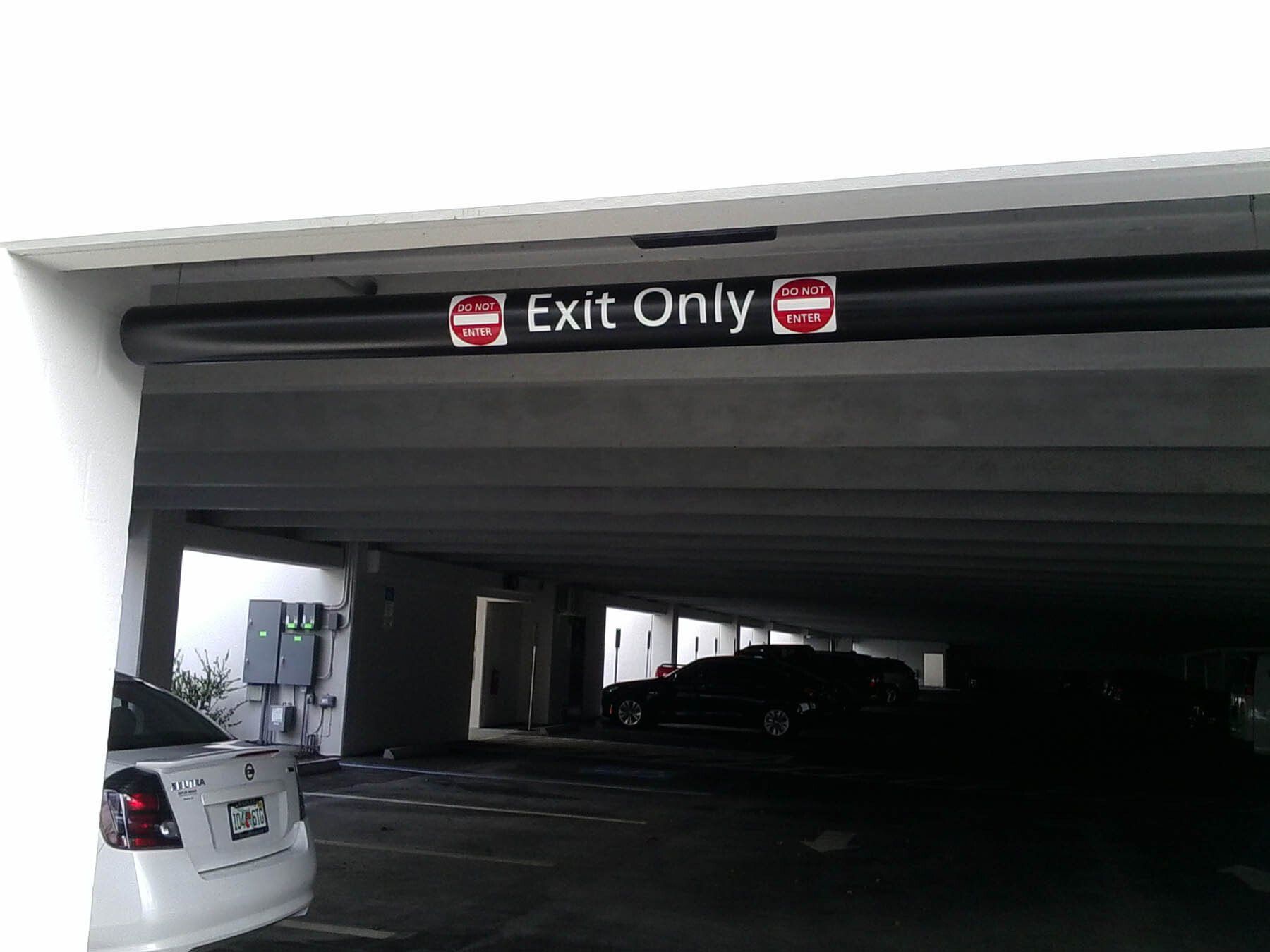 A sign in a parking garage says exit only