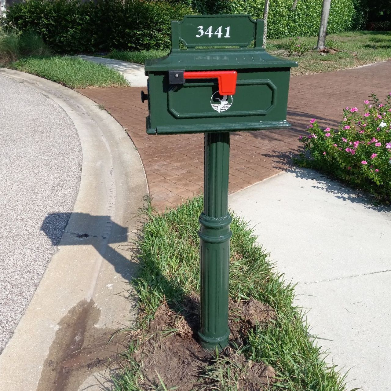 A green mailbox with the address 3441 on it