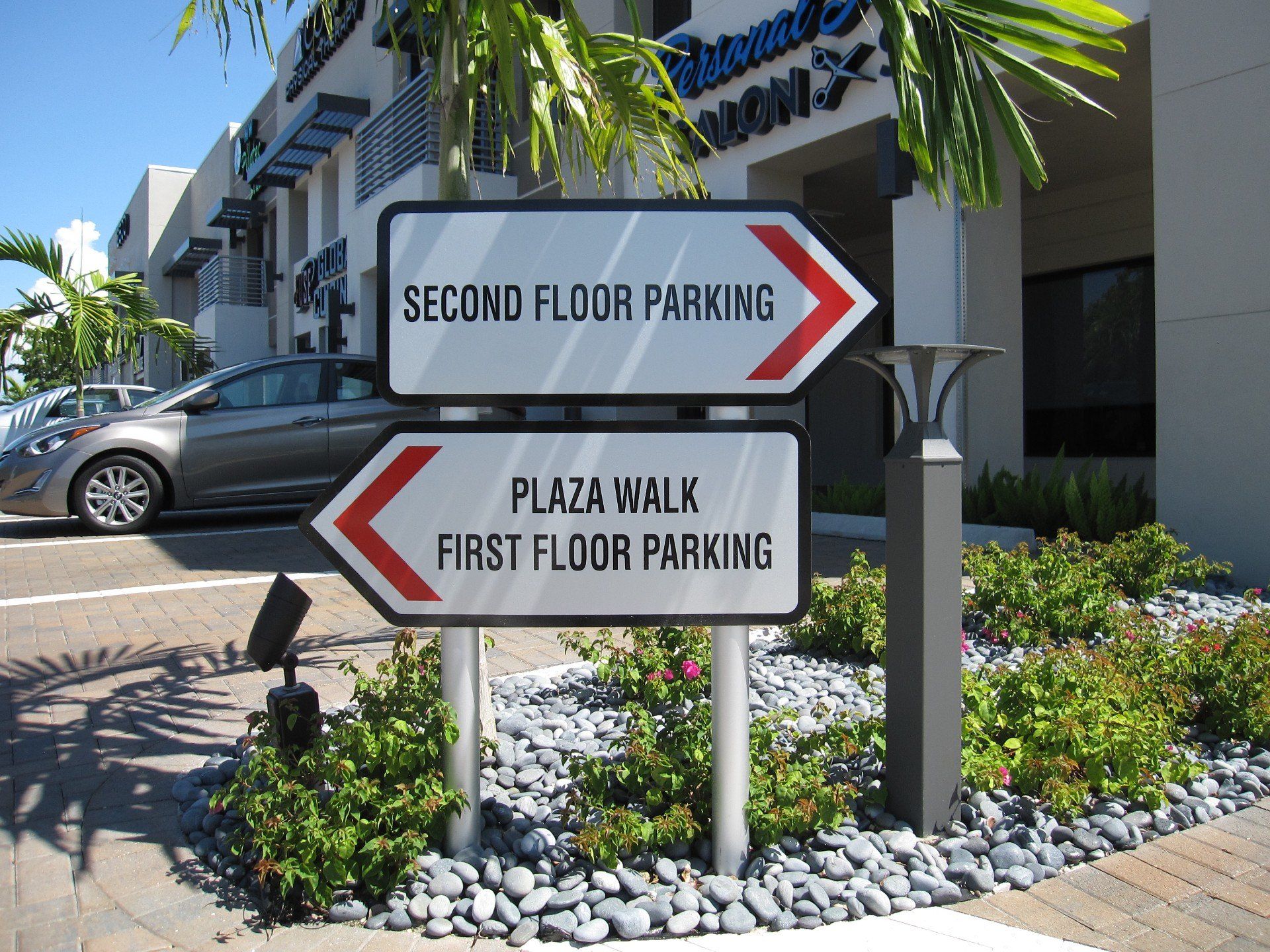 A sign for second floor parking and plaza walk first floor parking