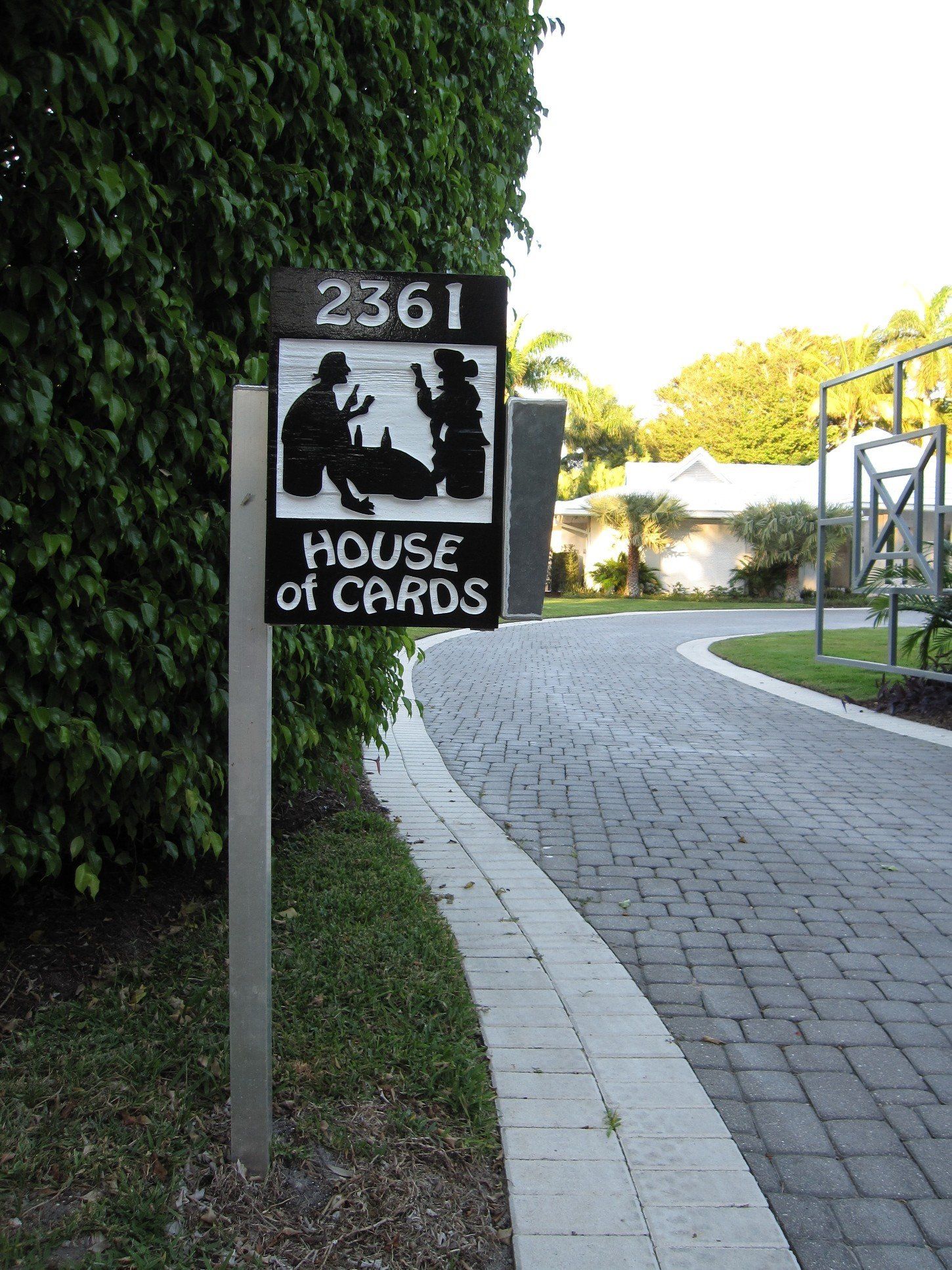 A sandblasted cedar address sign for Port Royal in Naples, painted black and white.