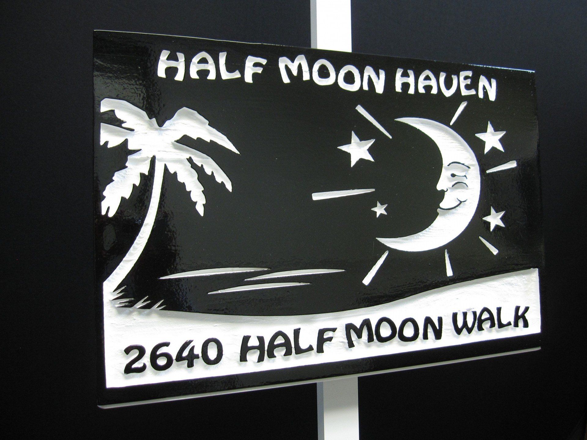 A sign that says half moon haven on it