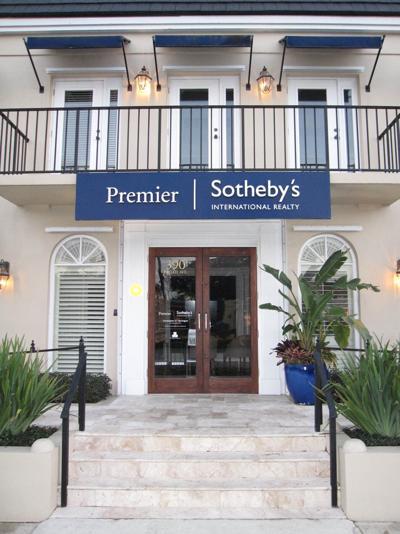 A building with a sign that says premier sotheby 's