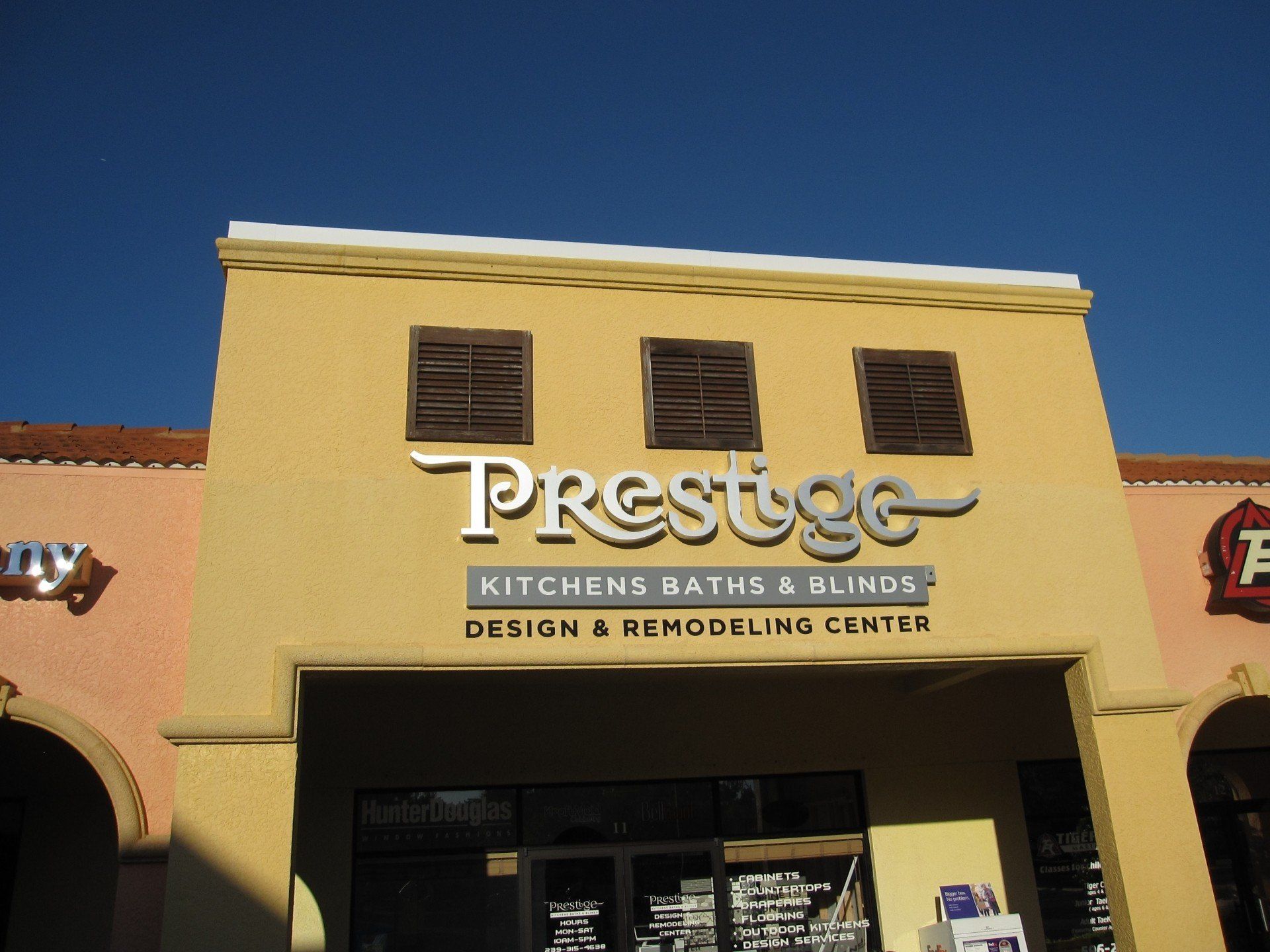 The front of a store called prestige kitchens baths and blinds