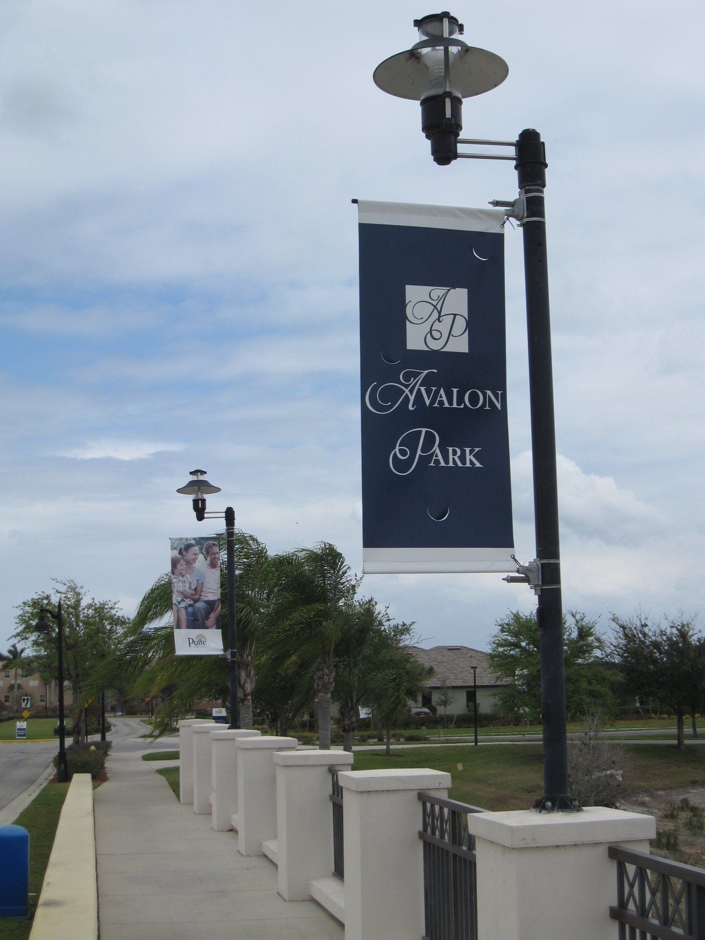 A sign for avalon park hangs from a street light