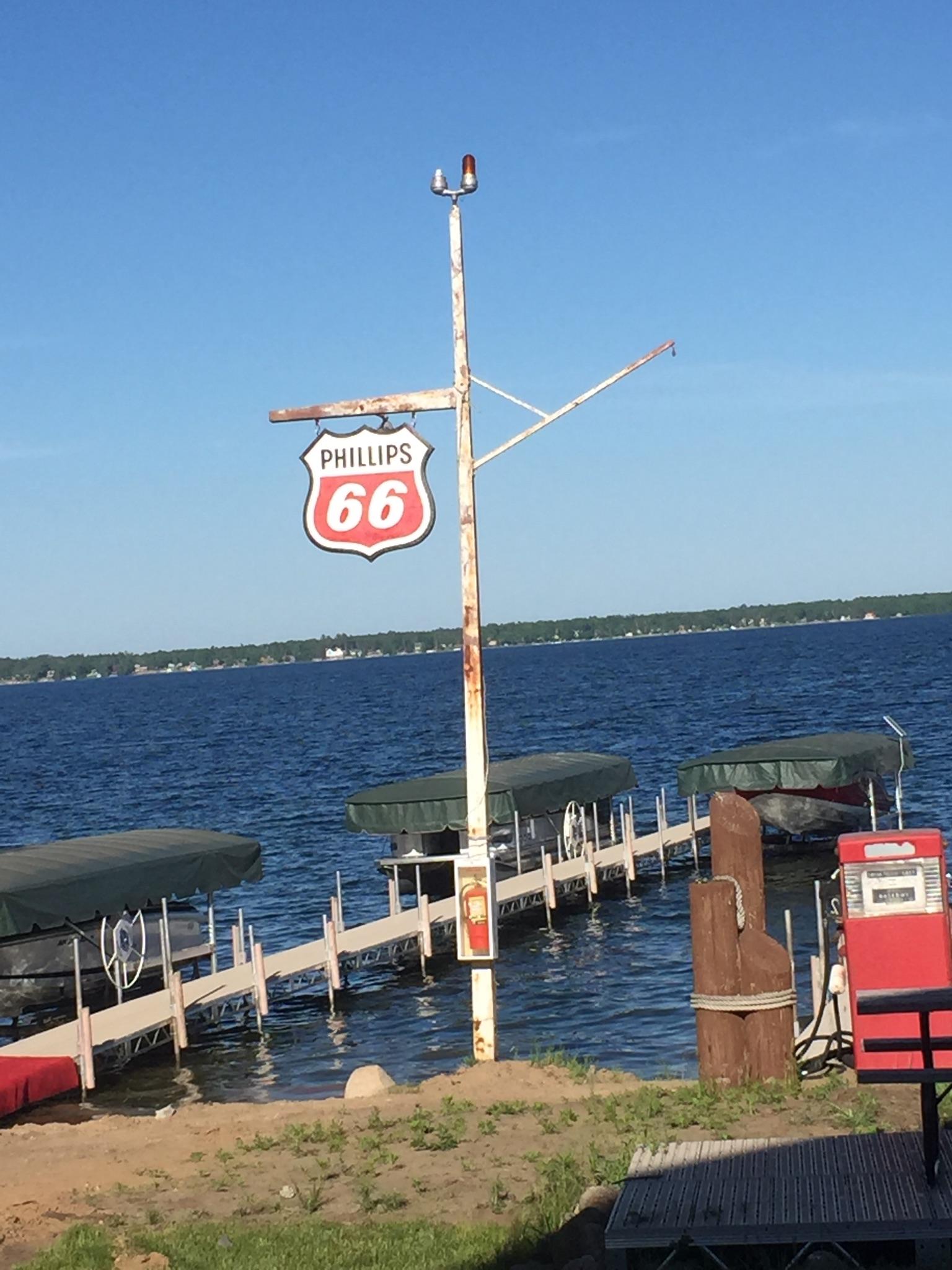 A sign on a pole that says route 66 on it