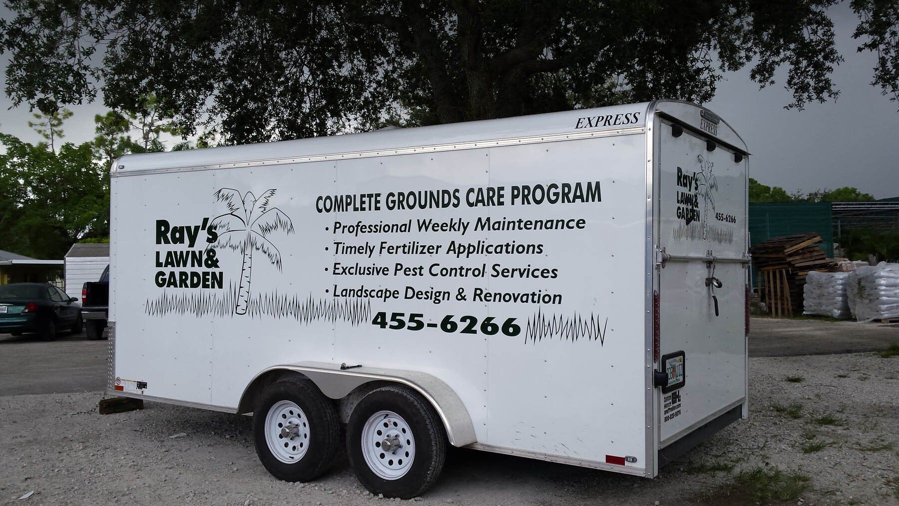 A white trailer for roy 's lawn and garden