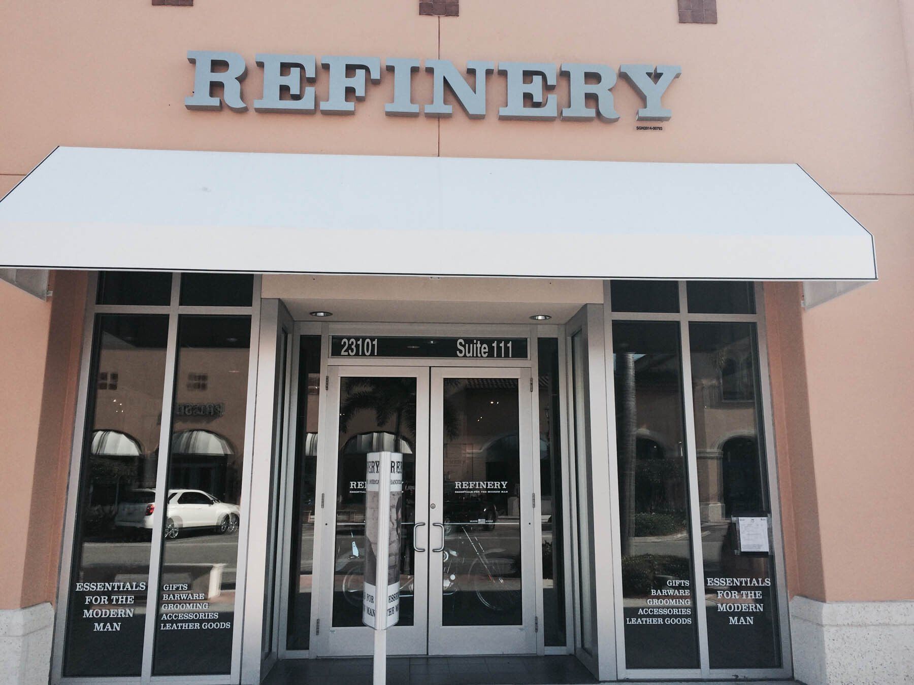 The front of a refinery store with a white awning