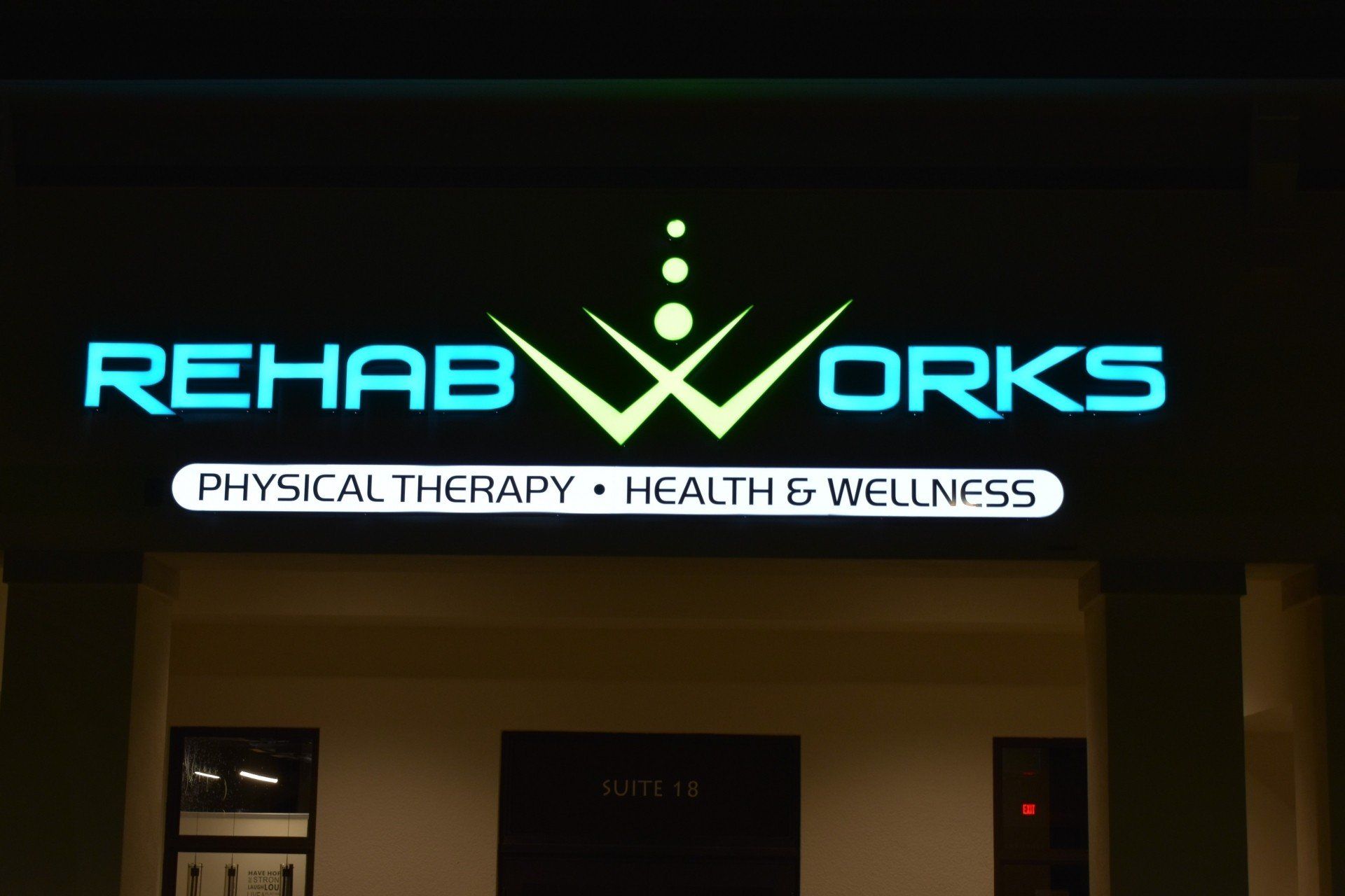 A neon sign for rehab works physical therapy health and wellness
