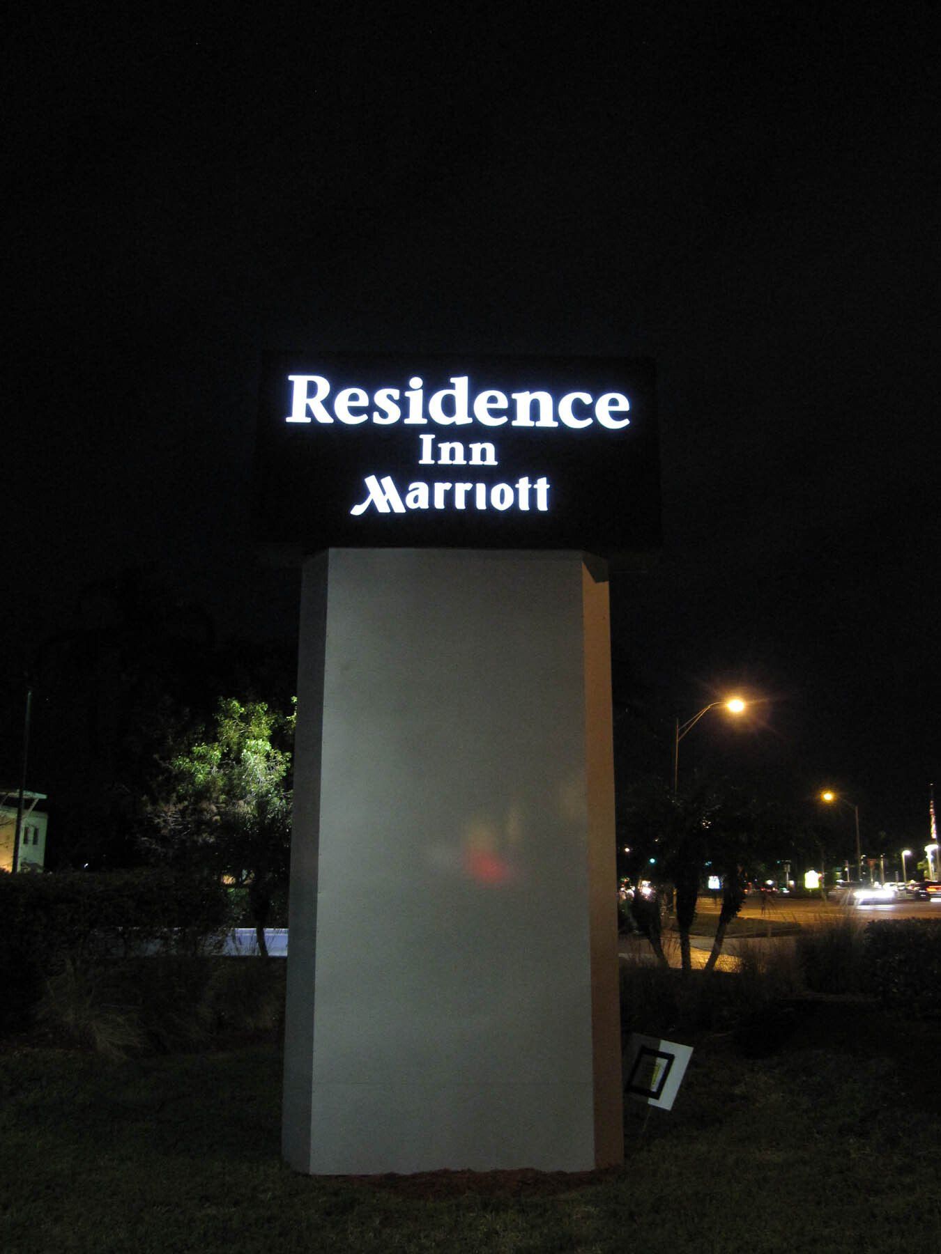 A residence inn marriott sign is lit up at night