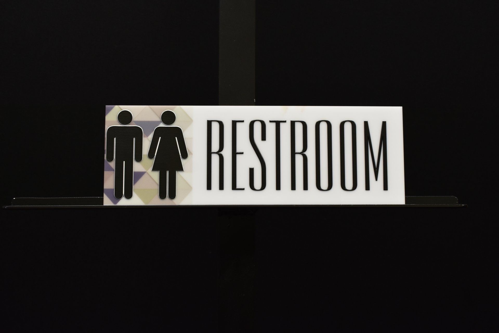 A restroom sign with a man and a woman on it