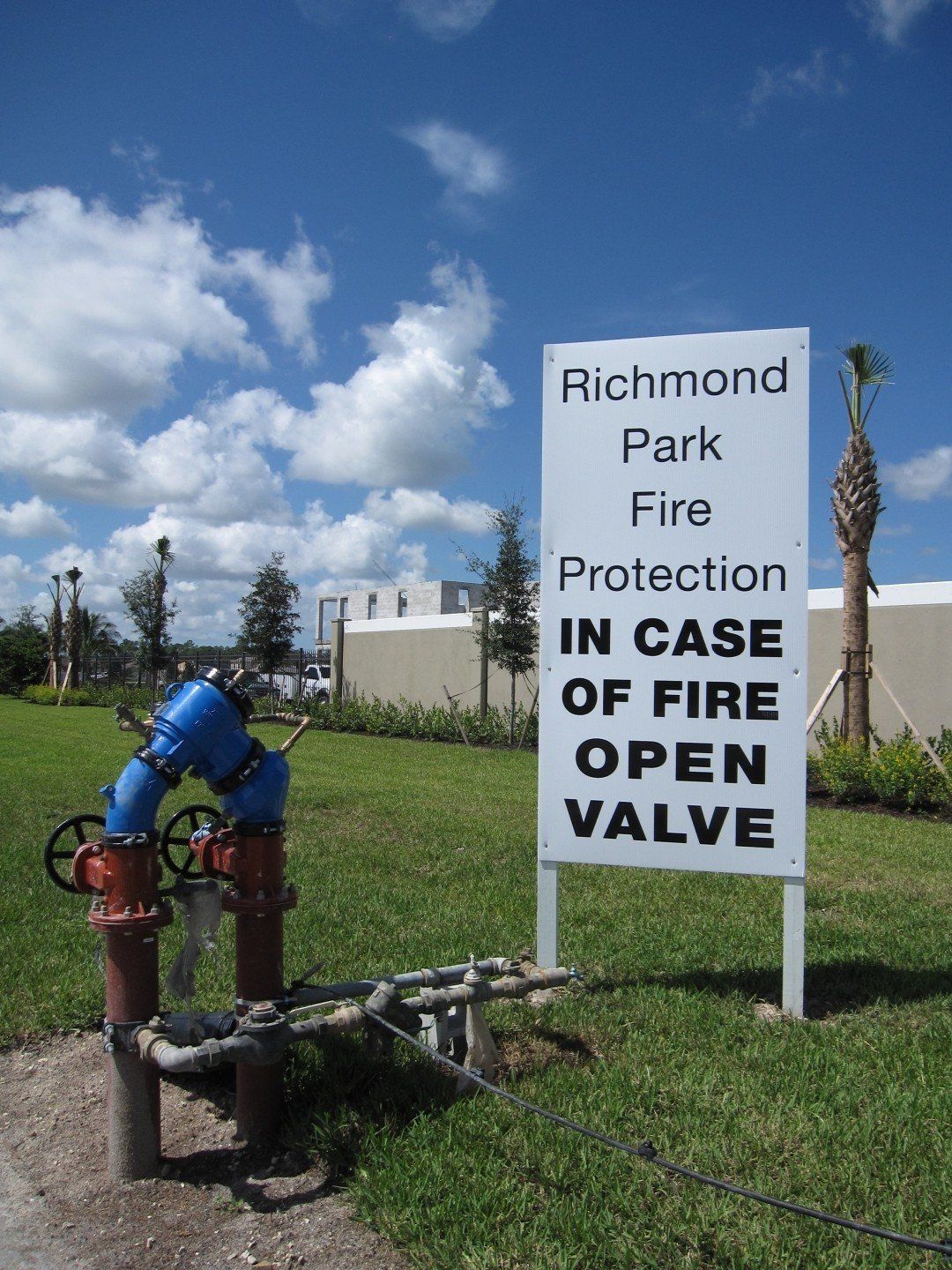 A sign that says richmond park fire protection in case of fire open valve