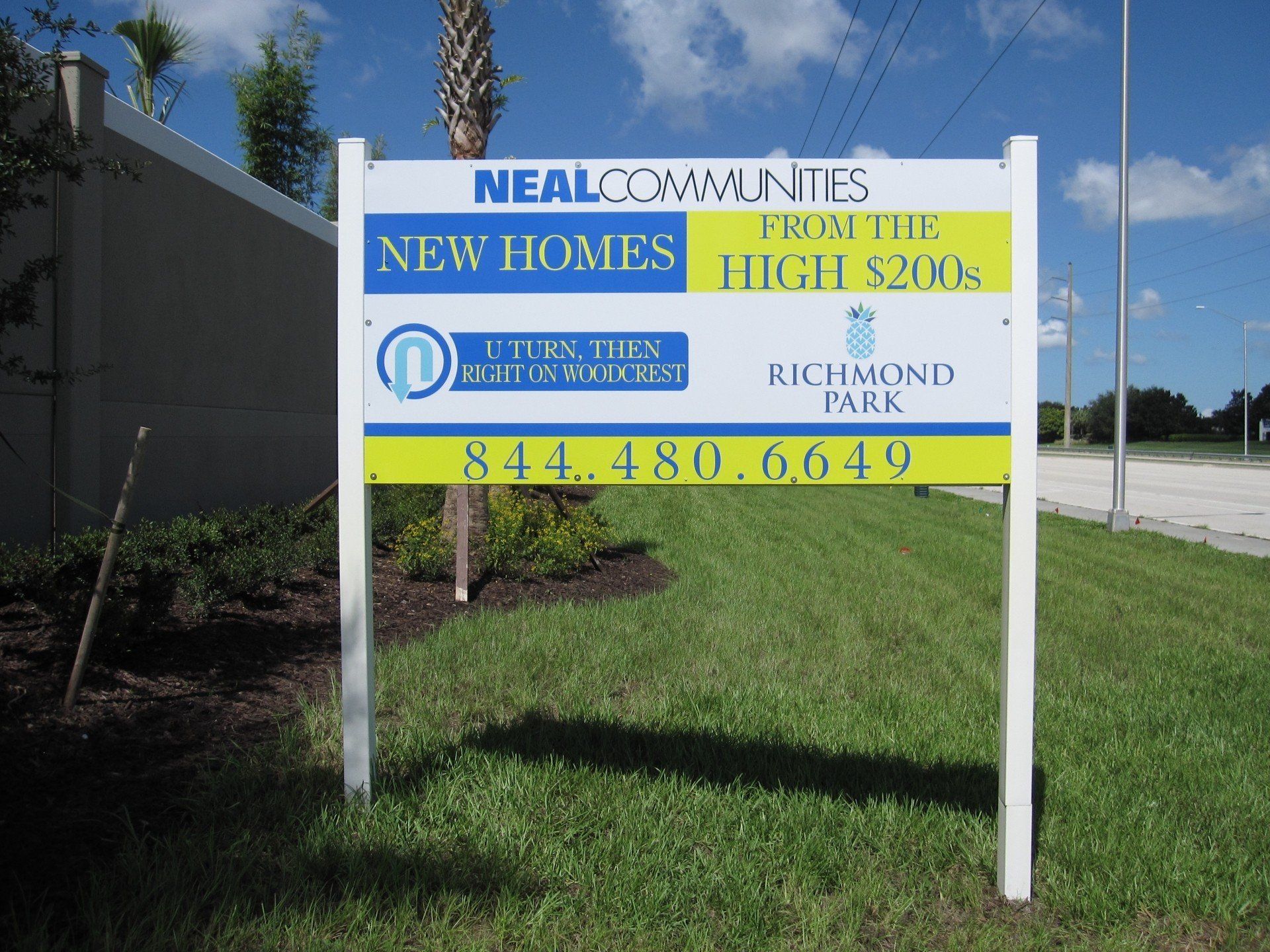 A sign that says neal communities new homes on it