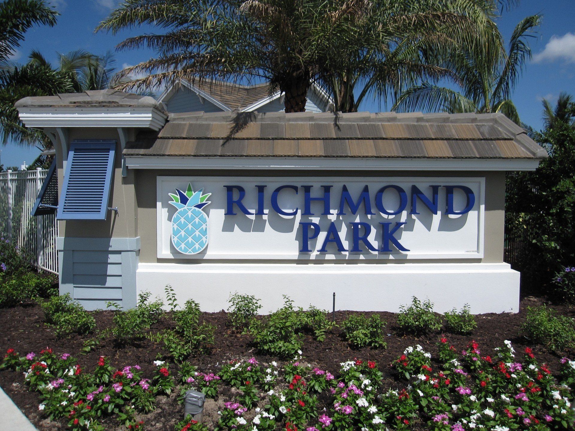 A sign for richmond park is surrounded by flowers