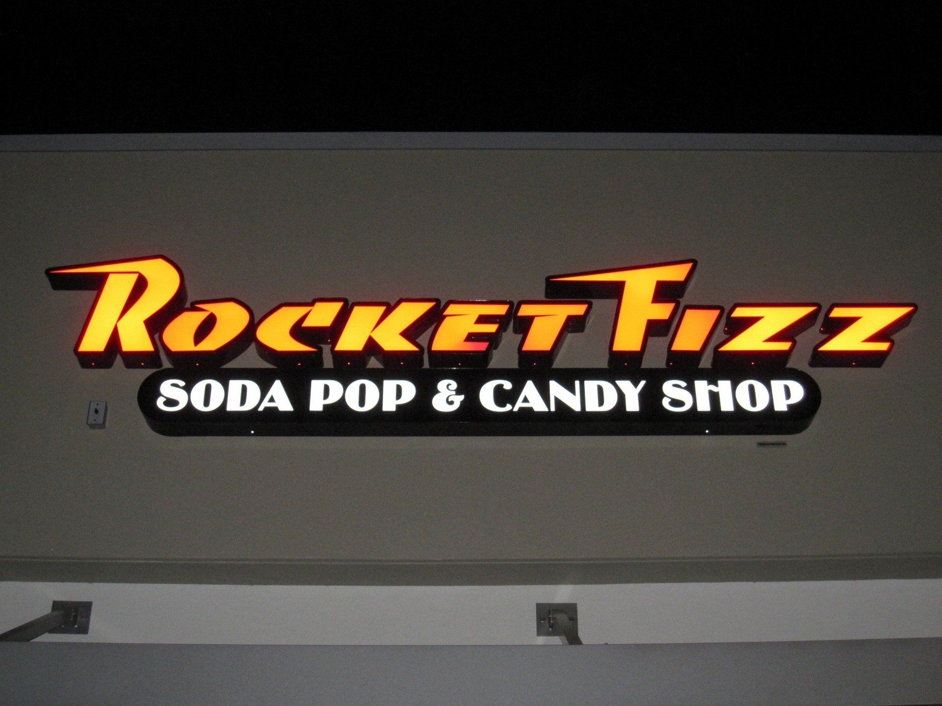 A sign for rocket fizz soda pop and candy shop