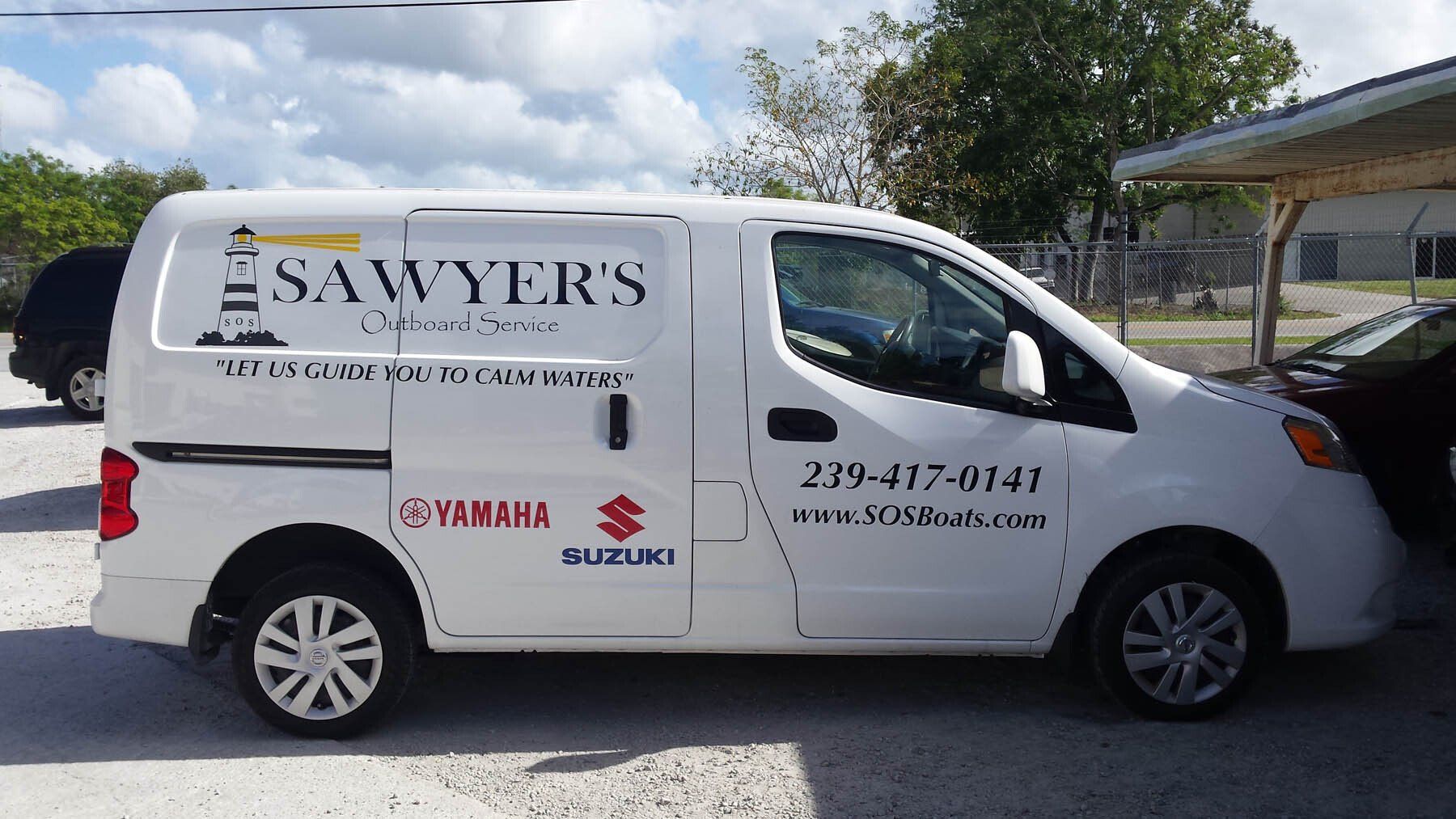 A white van that says sawyers is parked in a parking lot