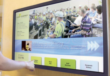A person is pointing at a screen that says safety meeting on it