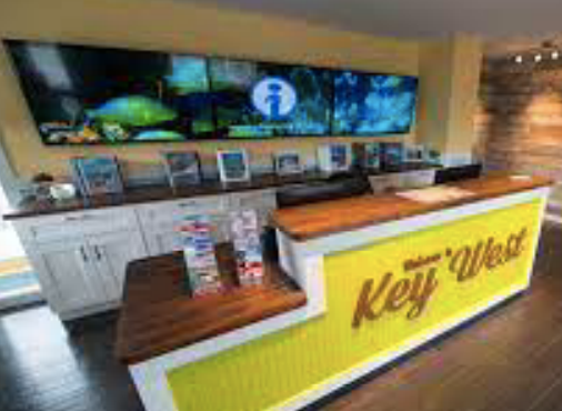A yellow and white counter in a room with a sign that says `` key west ''.