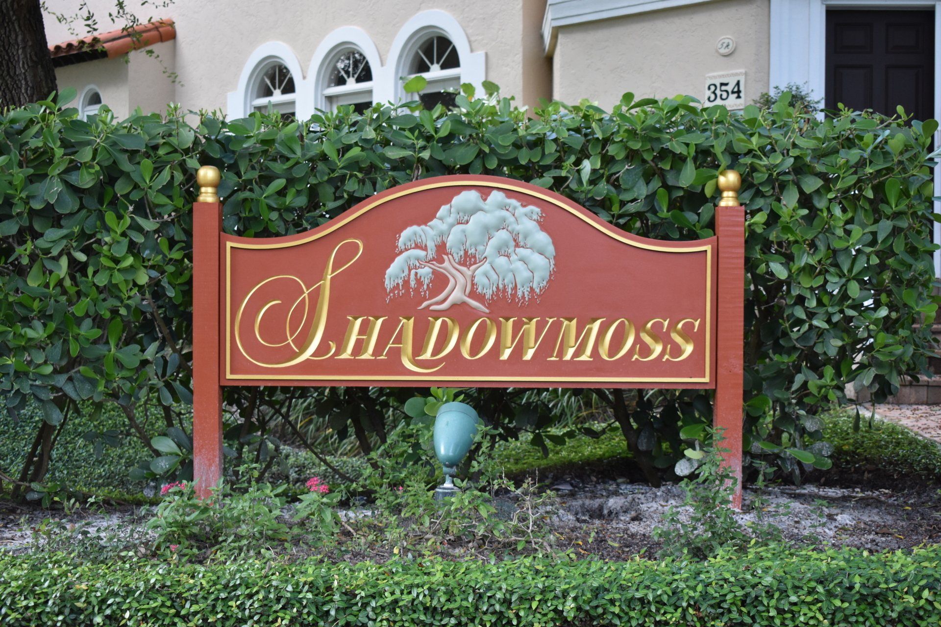A sign that says shadow moss in front of a house
