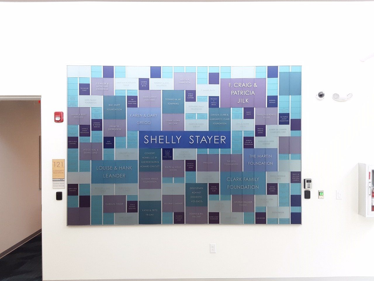 A large painting is hanging on a wall in a room.