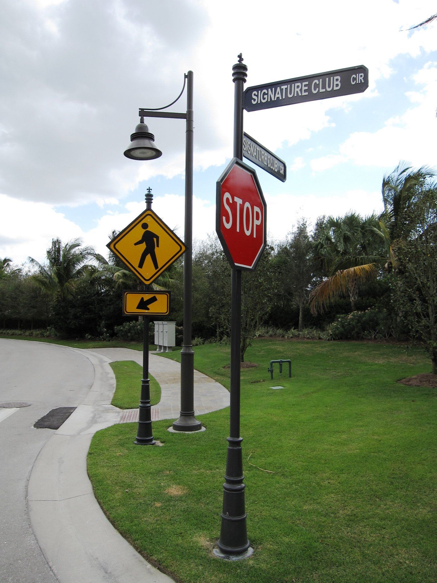 A stop sign is next to a crosswalk sign