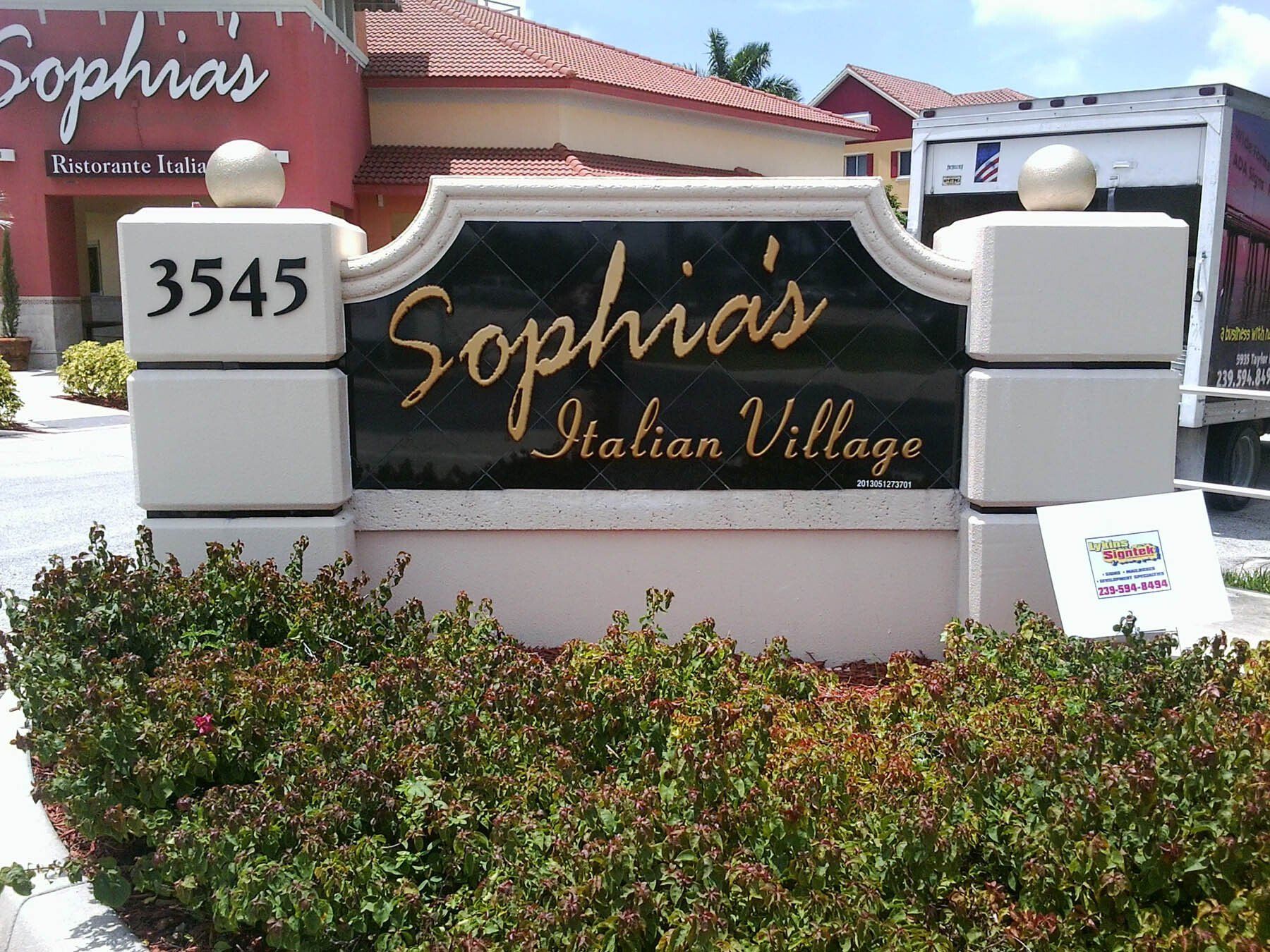 A sign that says sophia 's italian village on it