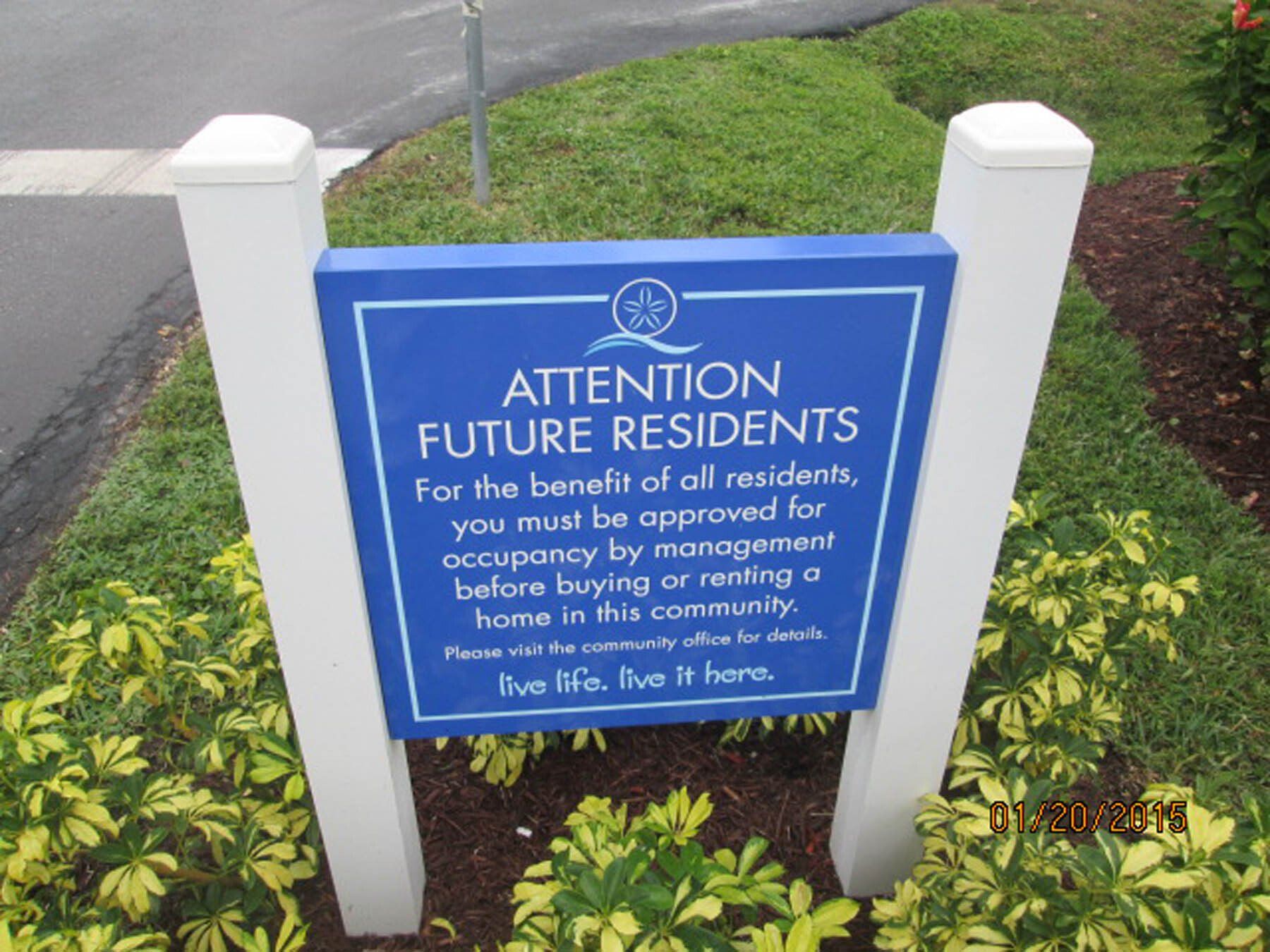 A blue sign that says attention future residents on it