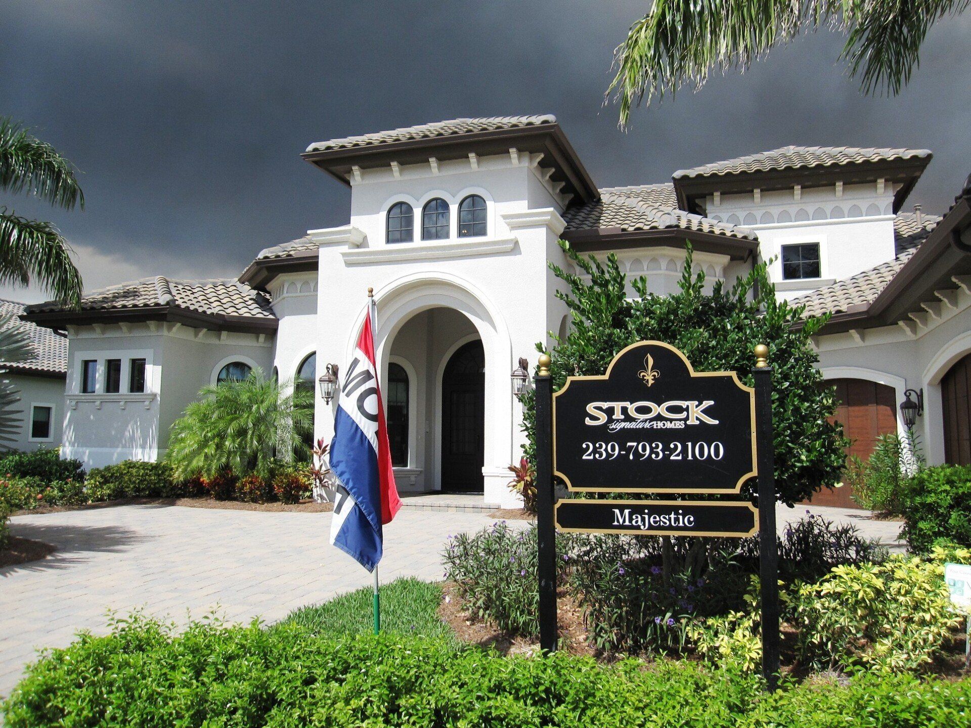 A large white house with a stock majestic sign in front of it