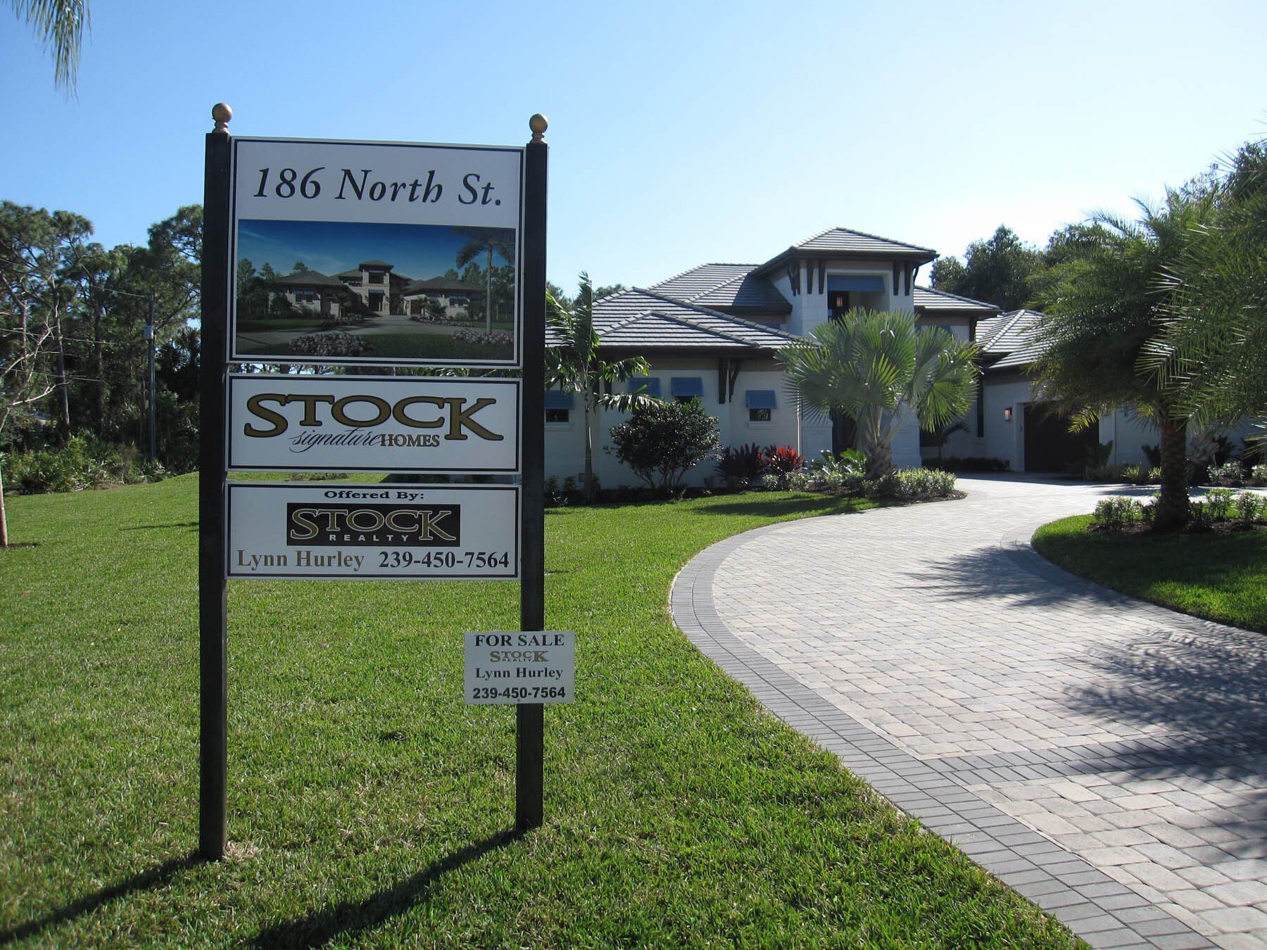 A sign that says stock on it in front of a house