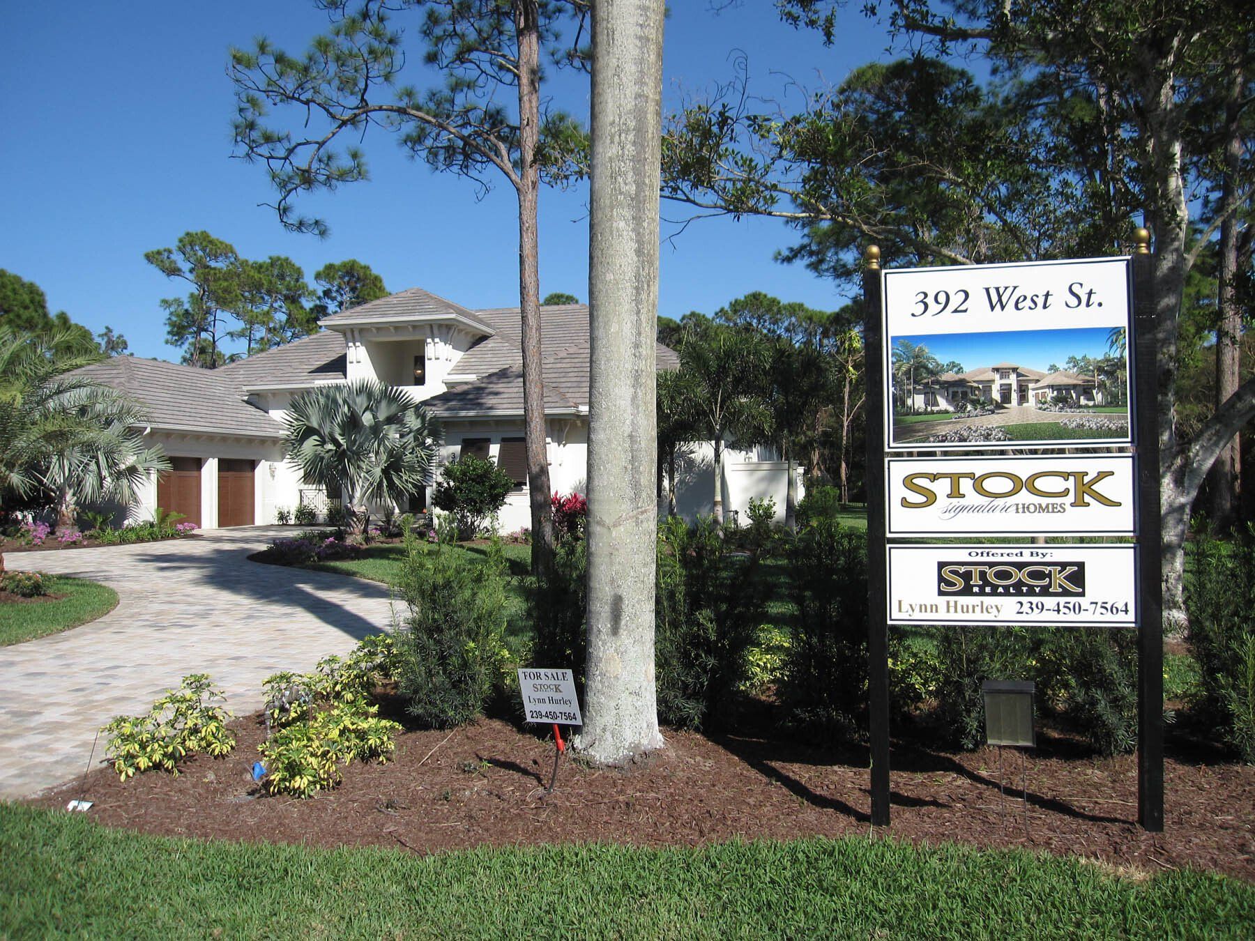 A house with a stock sign in front of it
