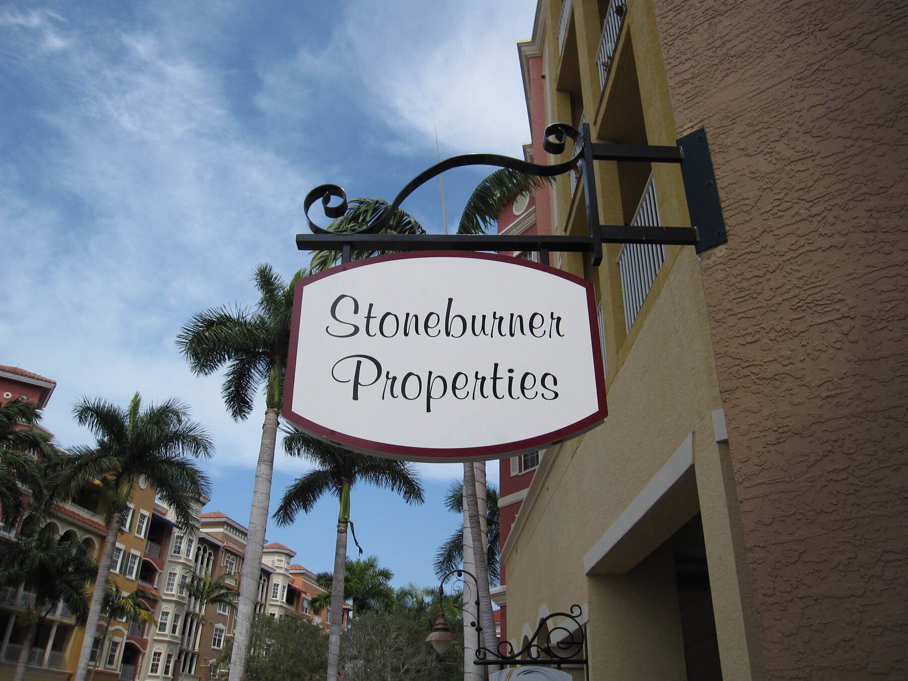 A stoneburner properties sign hangs from the side of a building