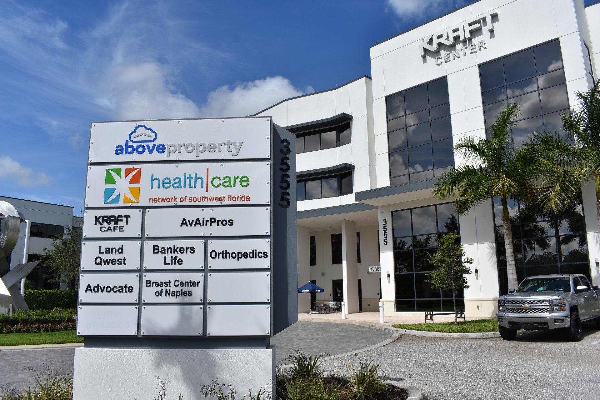 A building with a sign in front of it that says above property