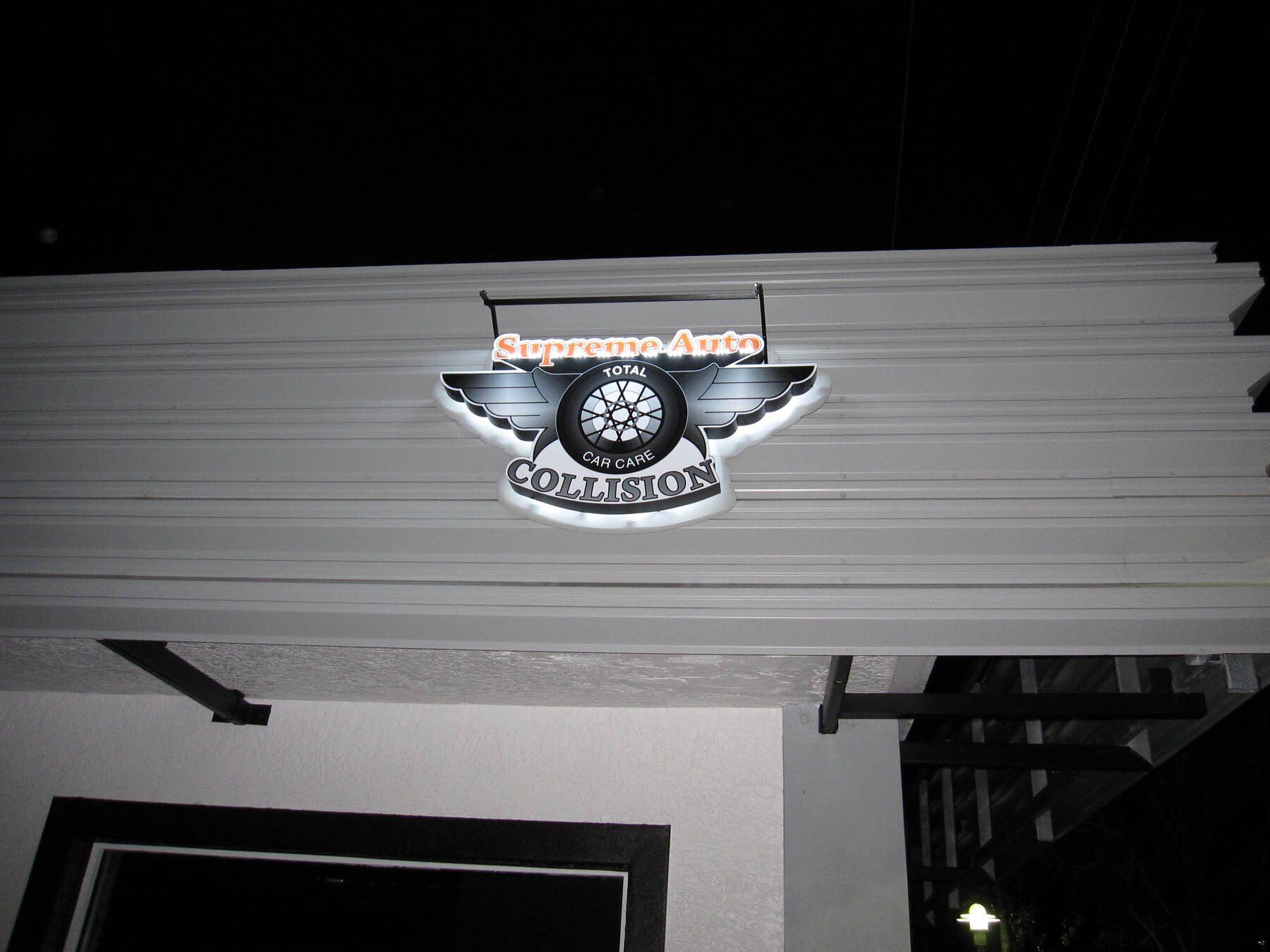 A sign on the side of a building that says superauto