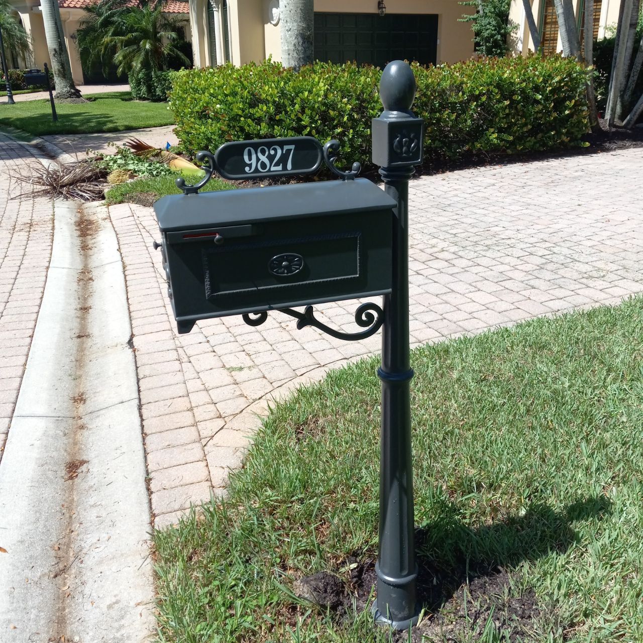 A black mailbox with the address 9827 on it