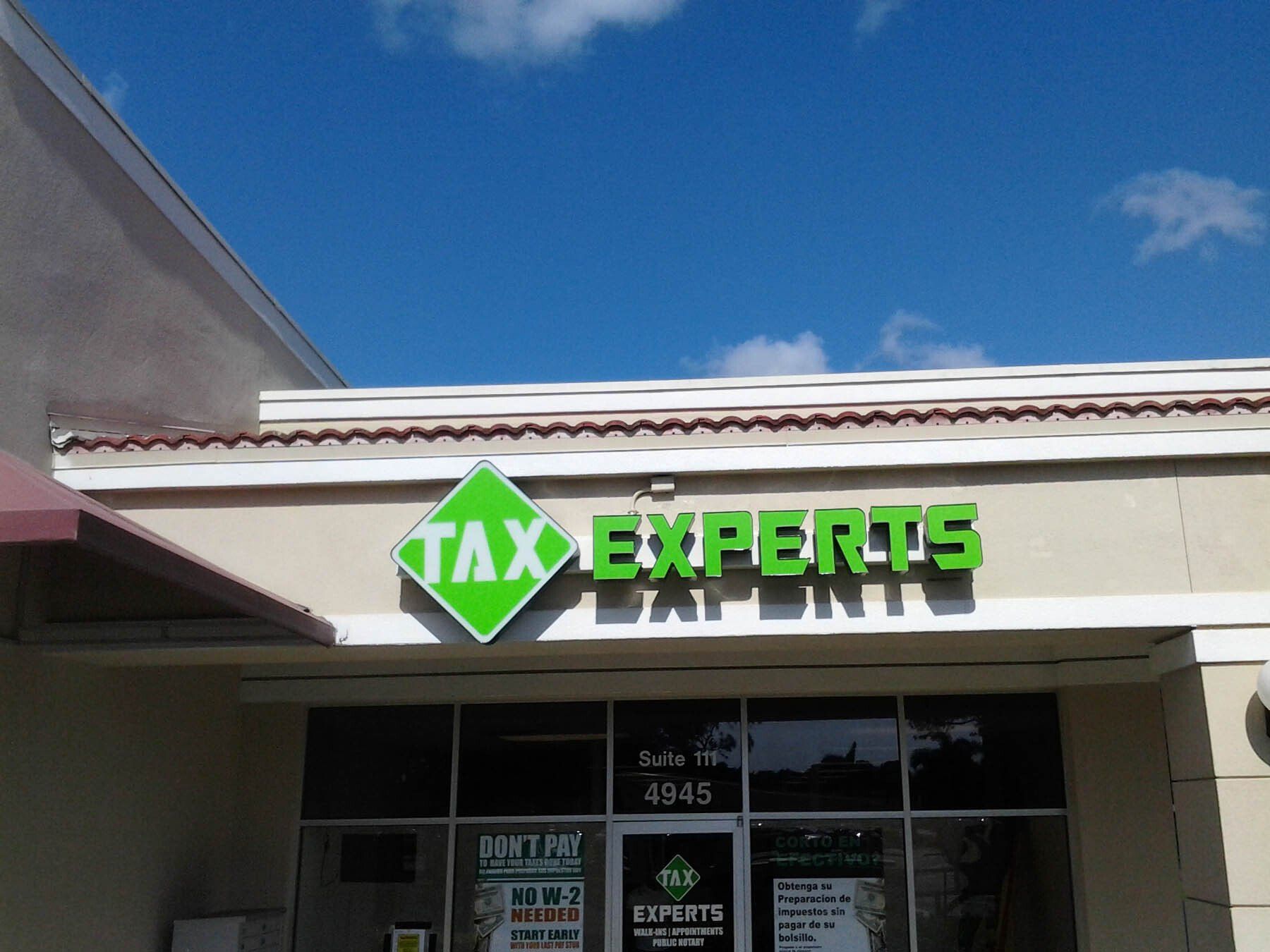 A building with a green sign that says tax experts