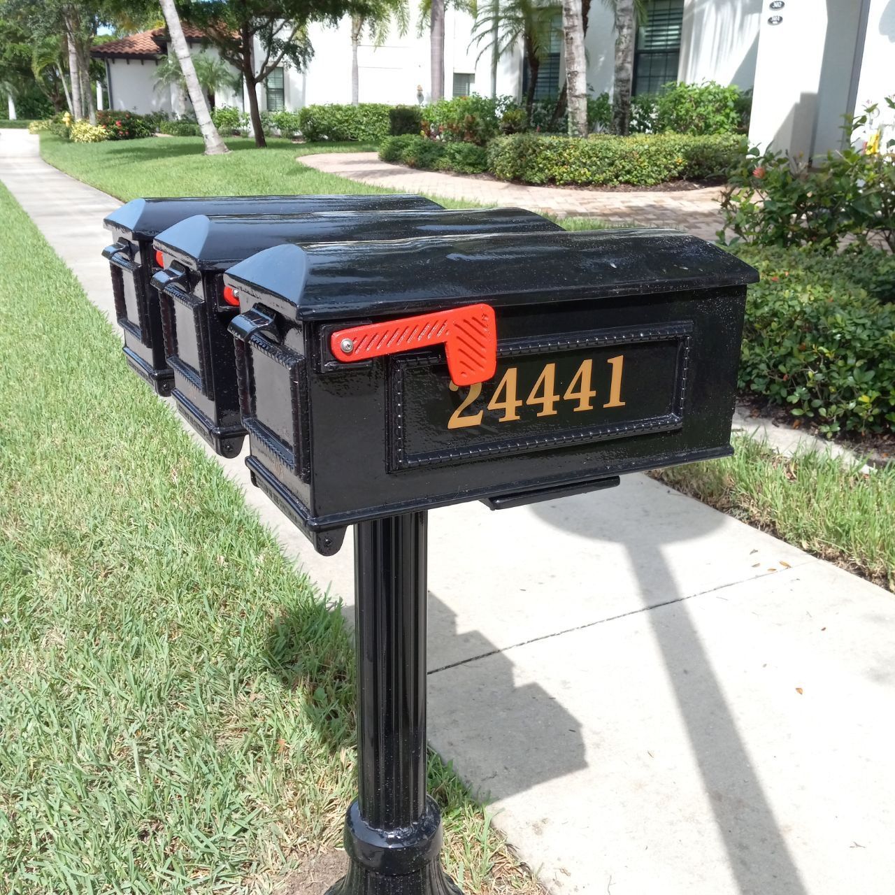 A black mailbox with the number 24441 on it