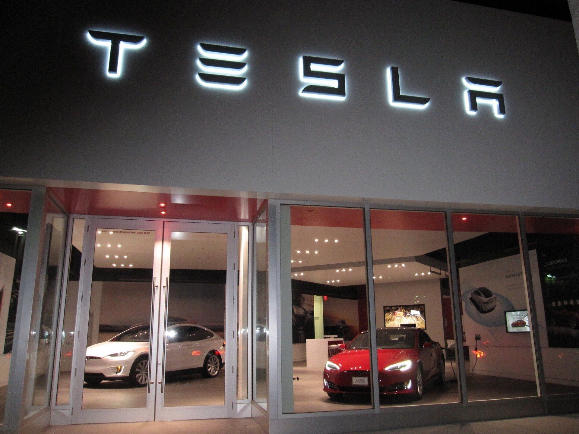 A tesla store with cars in the window