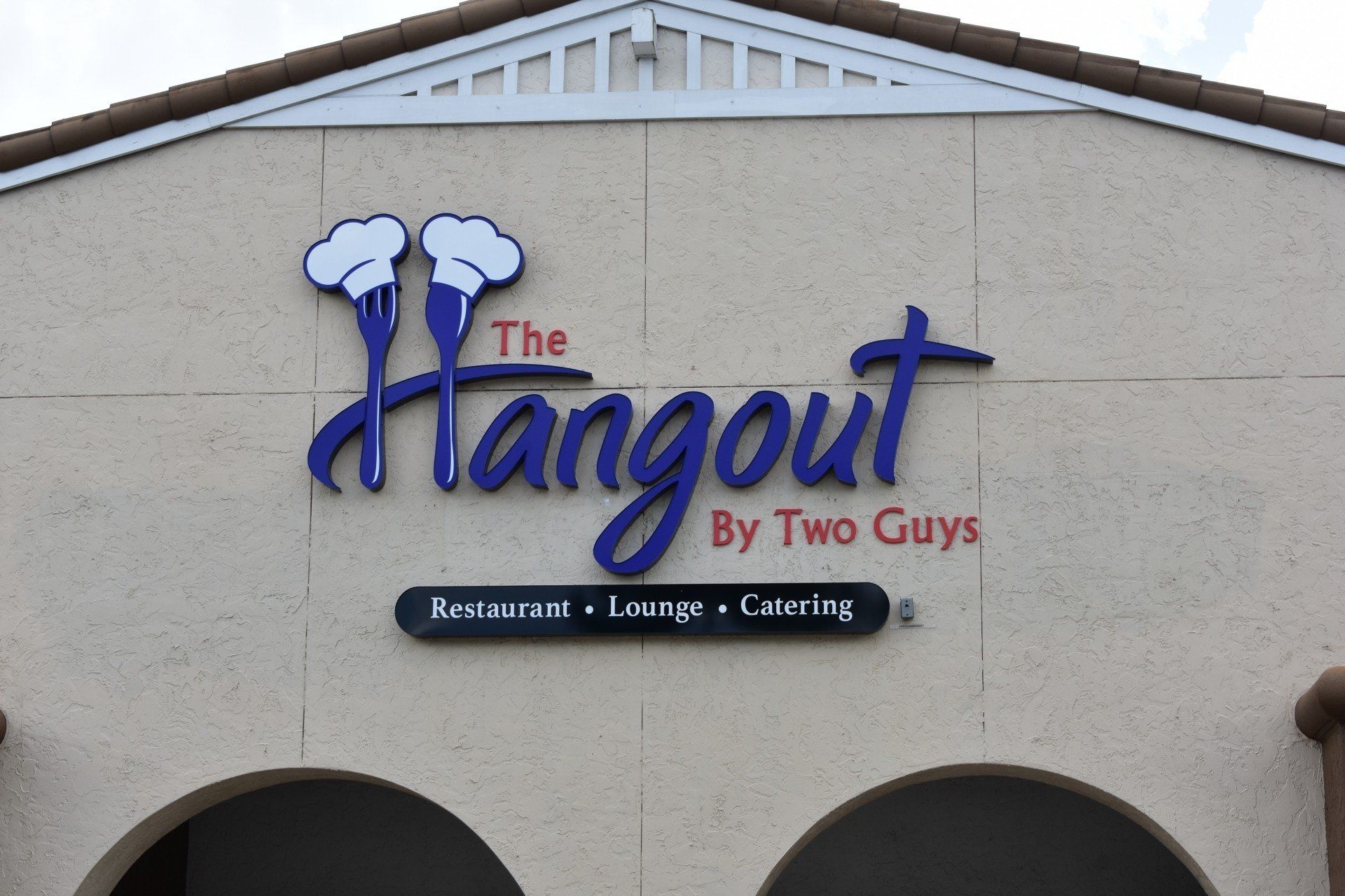 A sign for the hangout by two guys restaurant