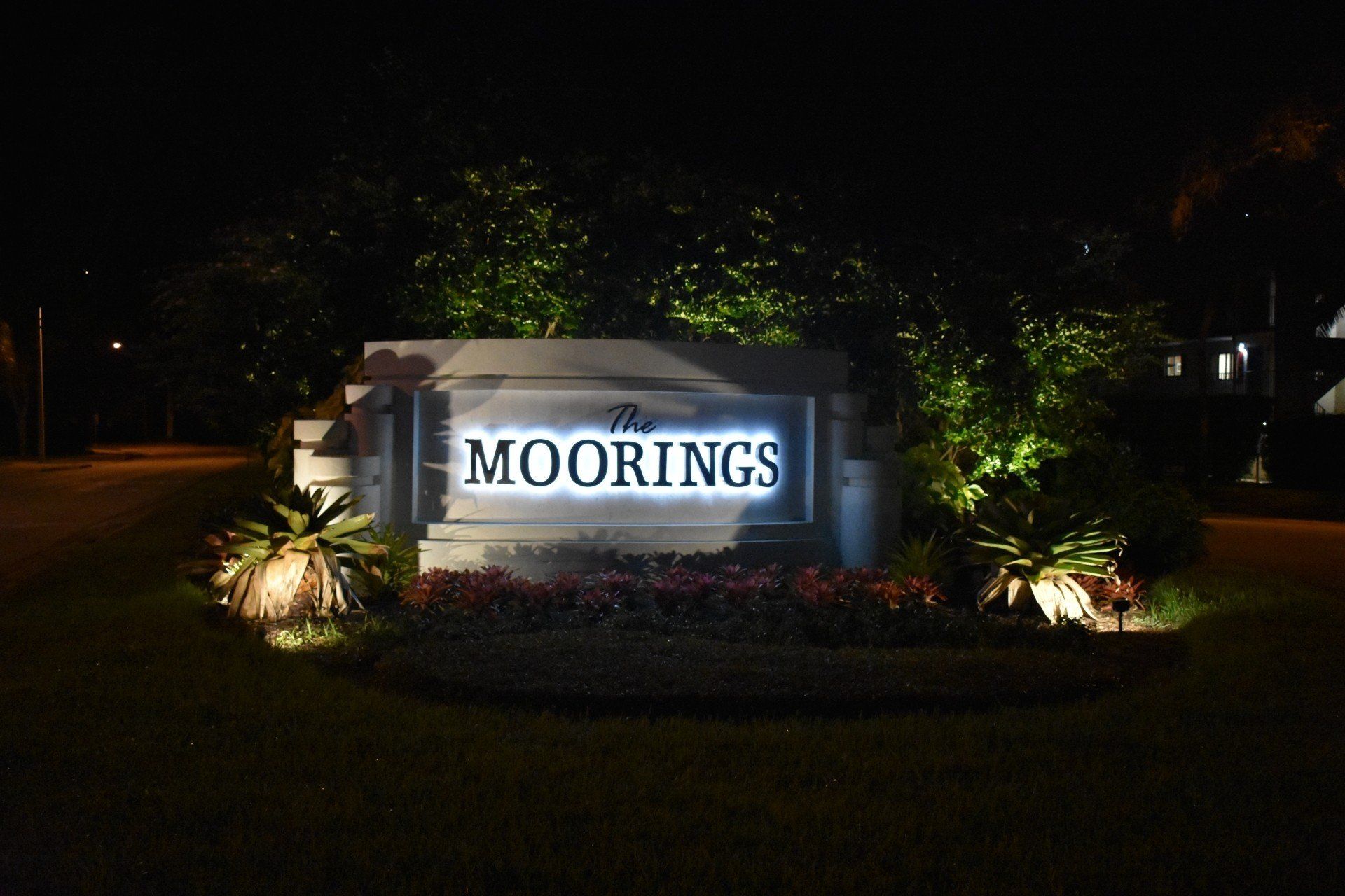 A sign for the moorings is lit up at night