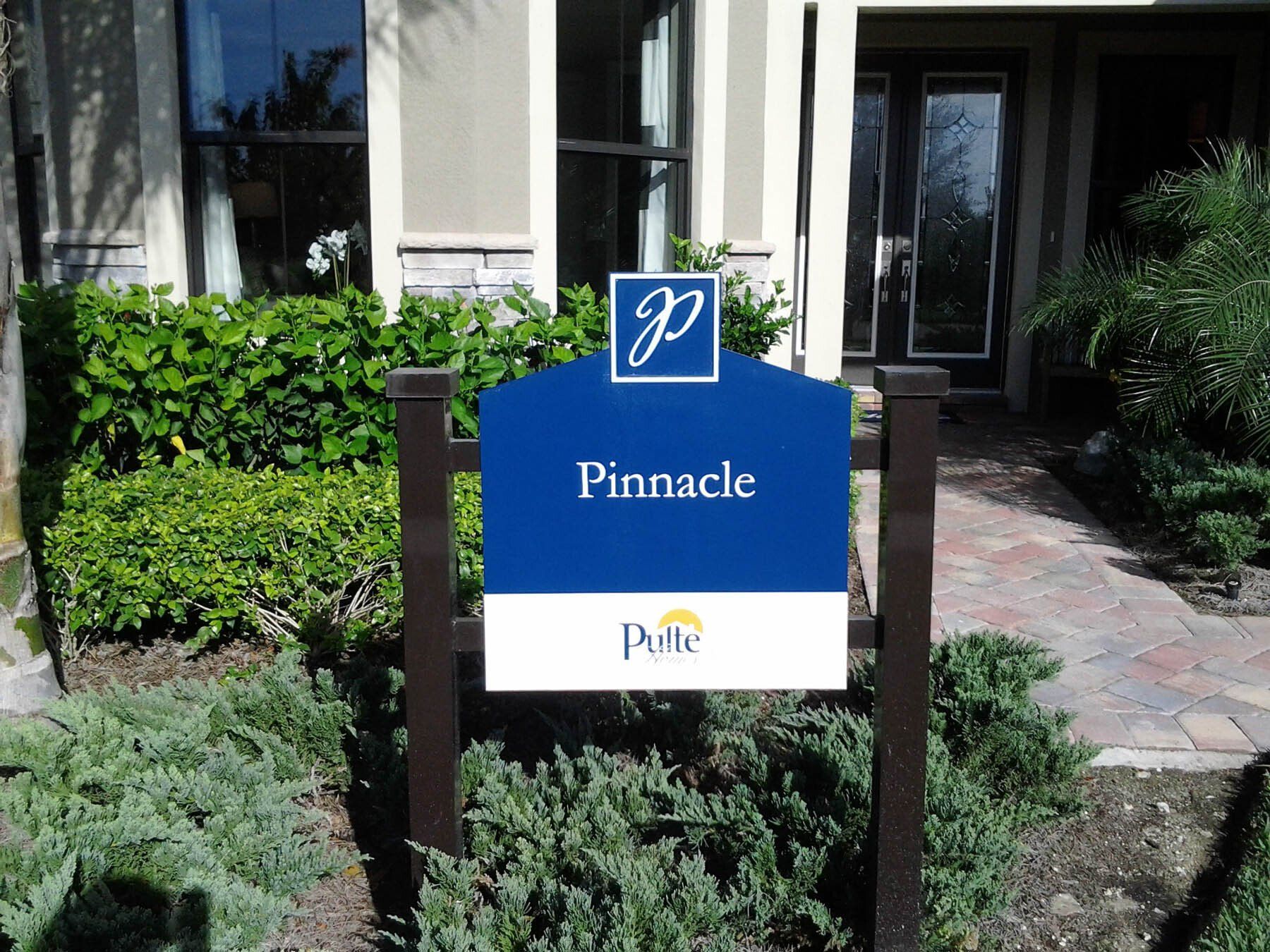 A blue and white sign that says pinnacle on it