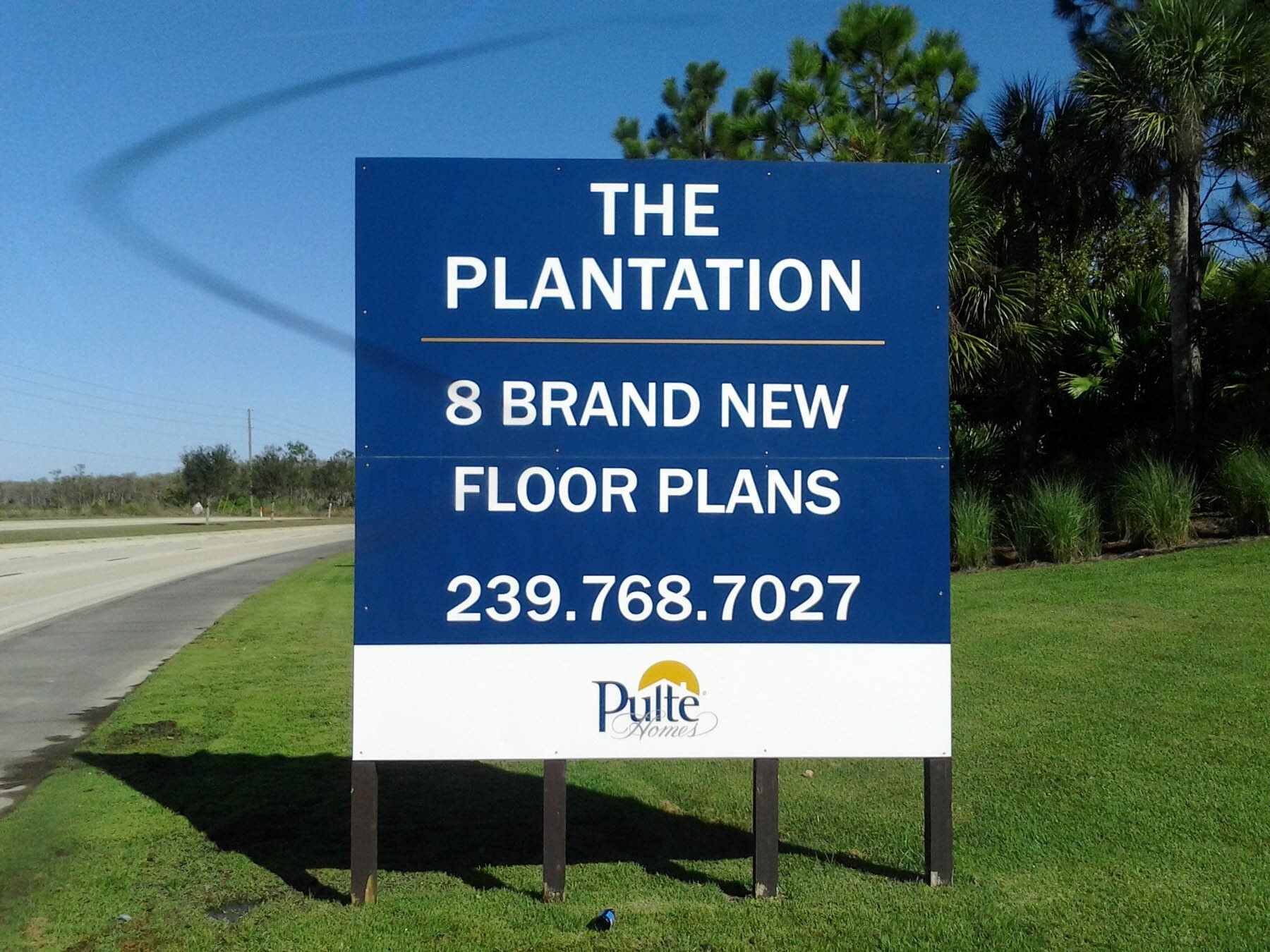A blue sign that says the plantation 8 brand new floor plans