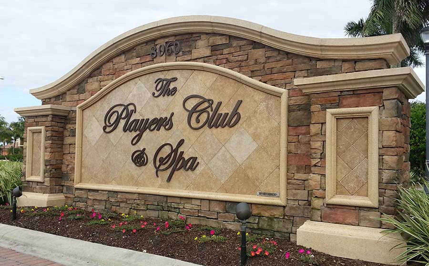 A large stone sign for the players club and spa