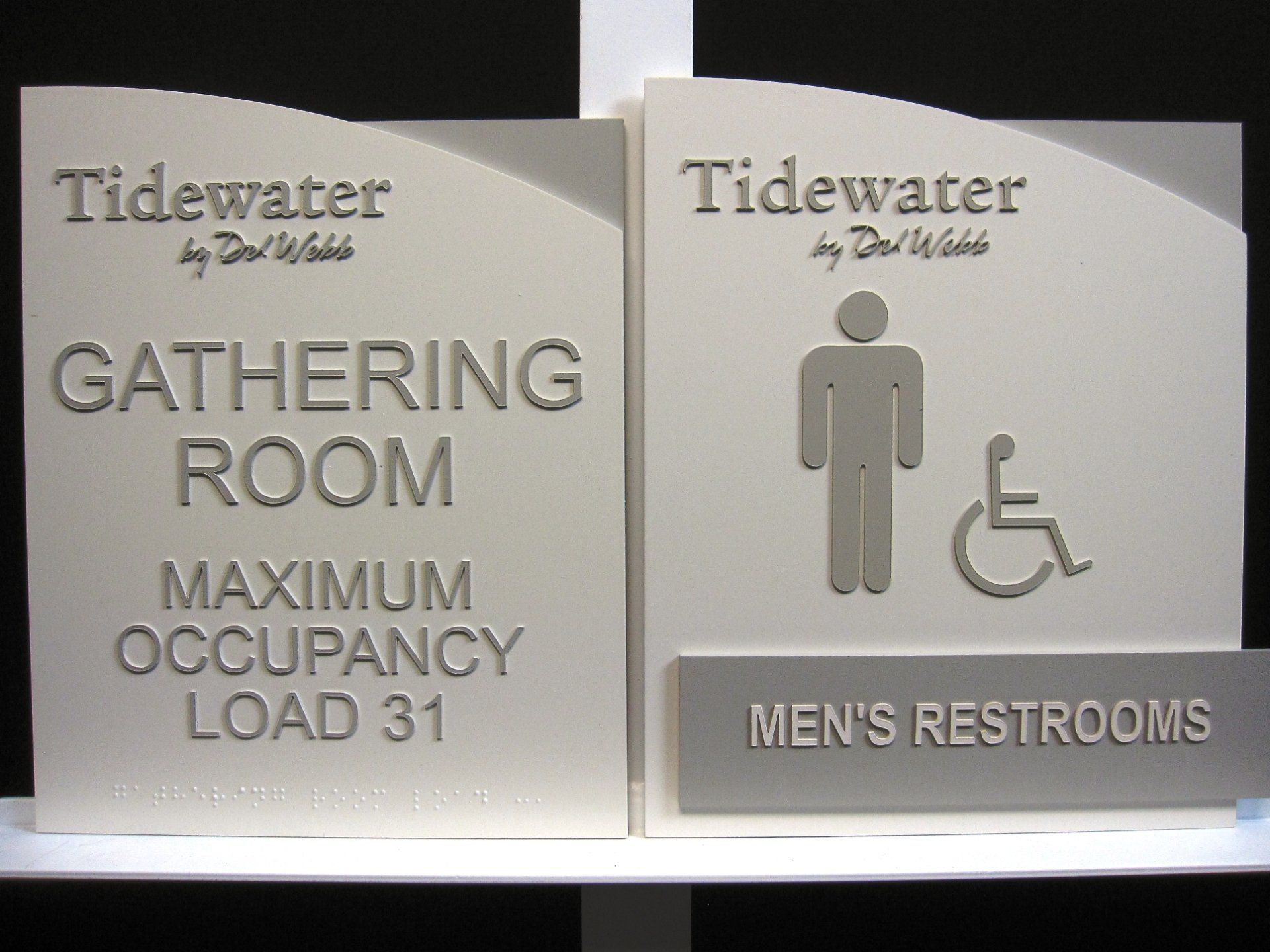 A sign for the tidewater gathering room and men 's restrooms