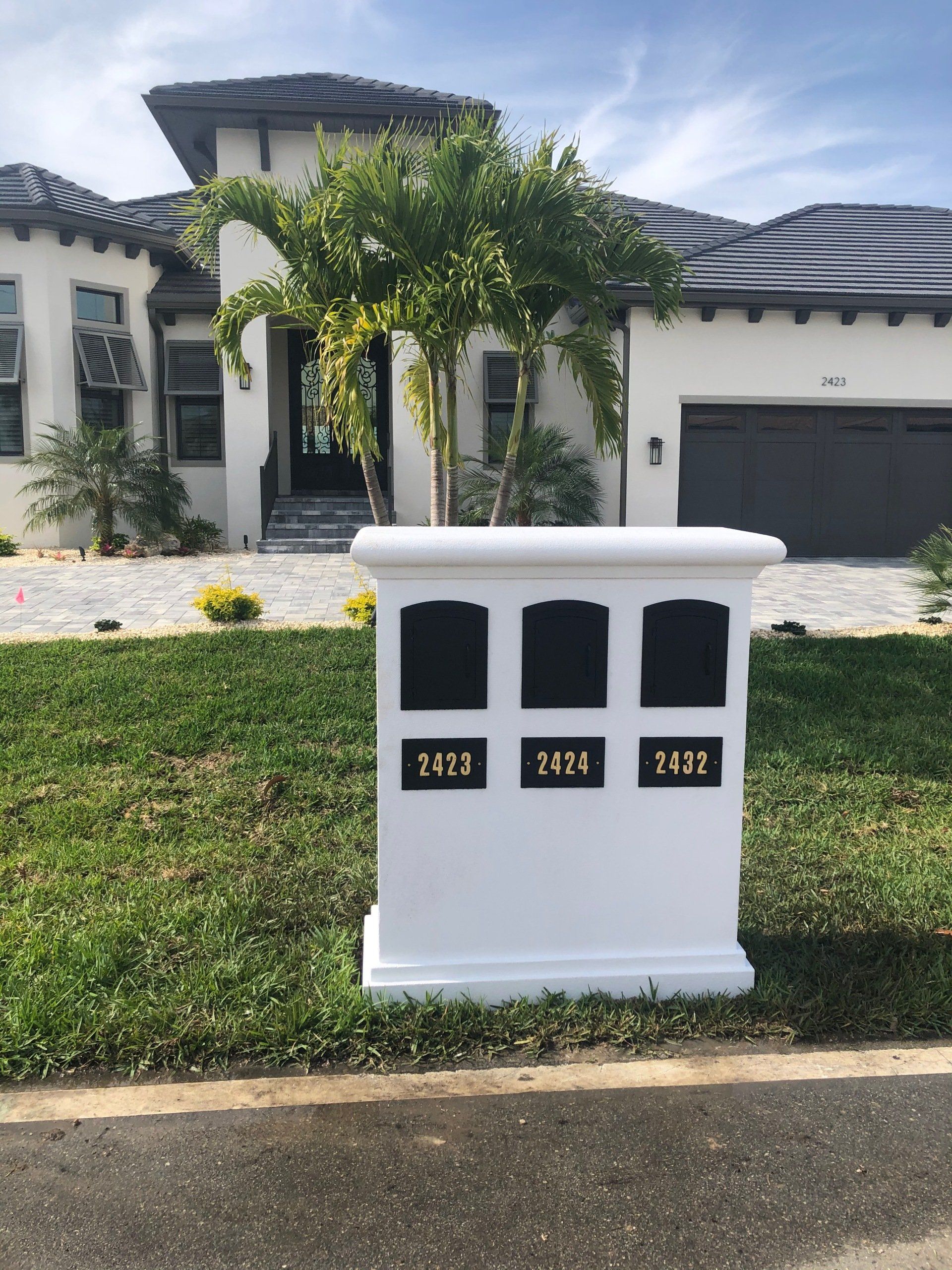 A white mailbox with the numbers 1427 1428 and 1441 on it