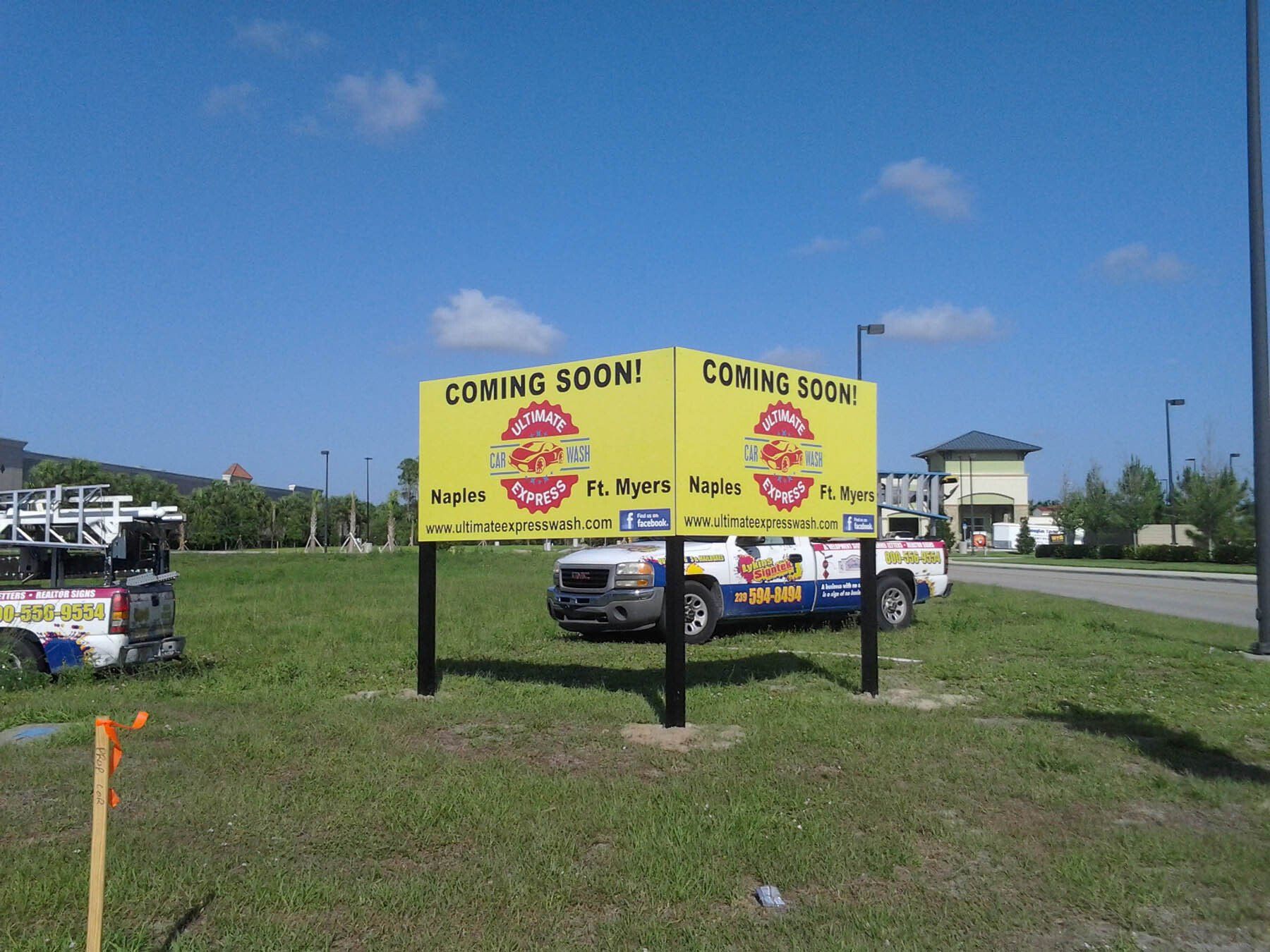 A yellow sign that says coming soon on it