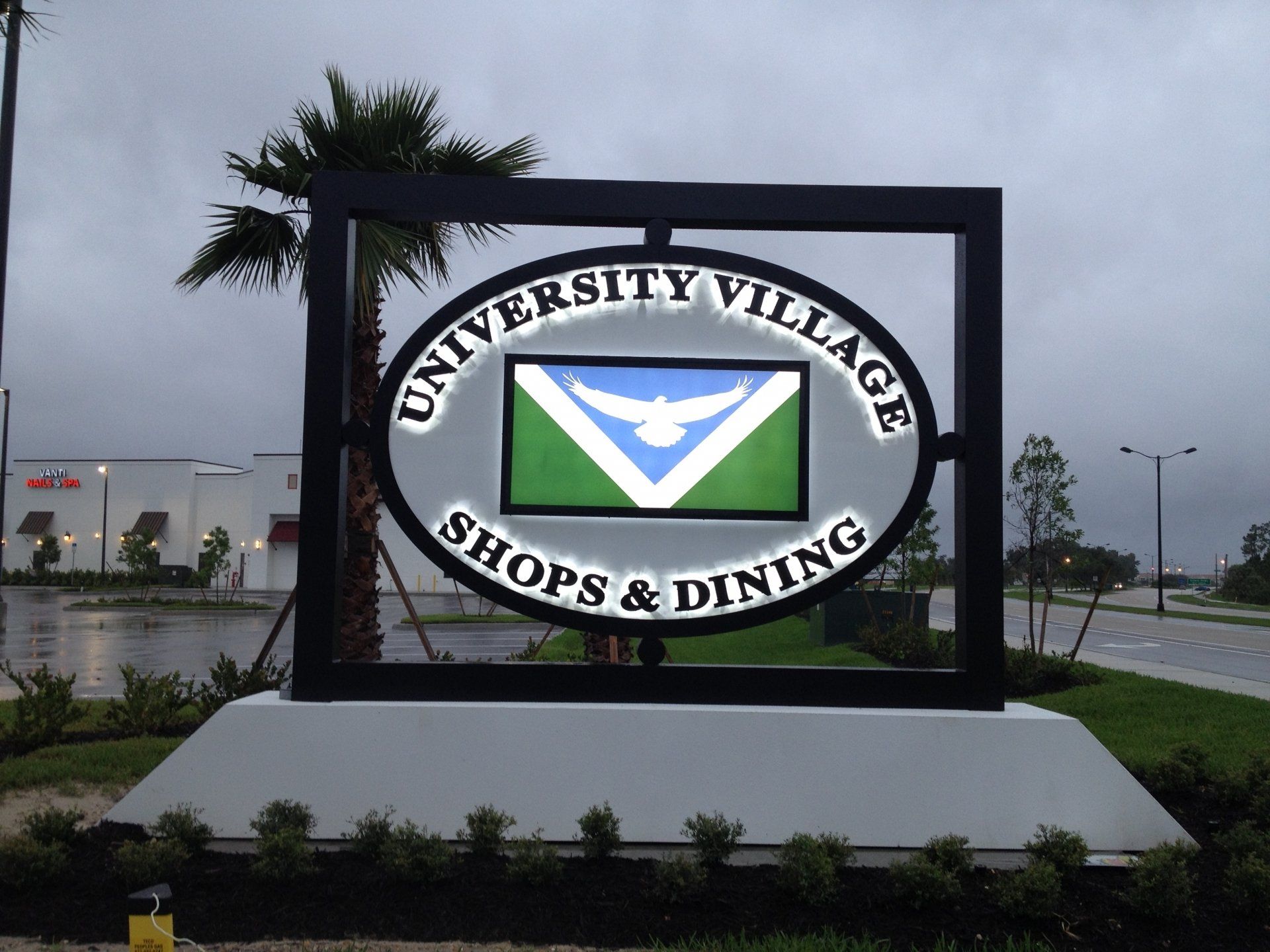 A sign for university village shops and dining