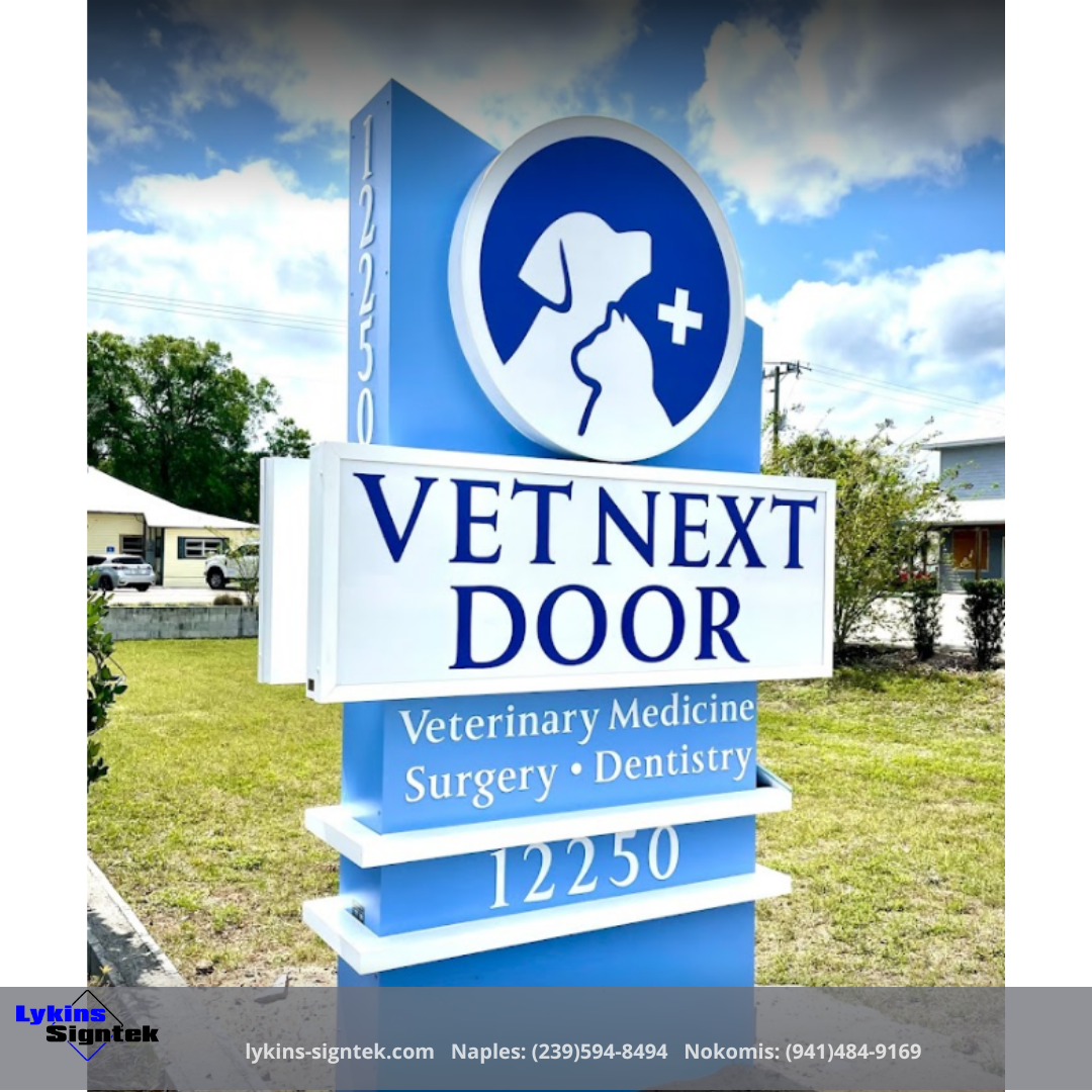A blue and white sign for vet next door veterinary medicine surgery and dentistry