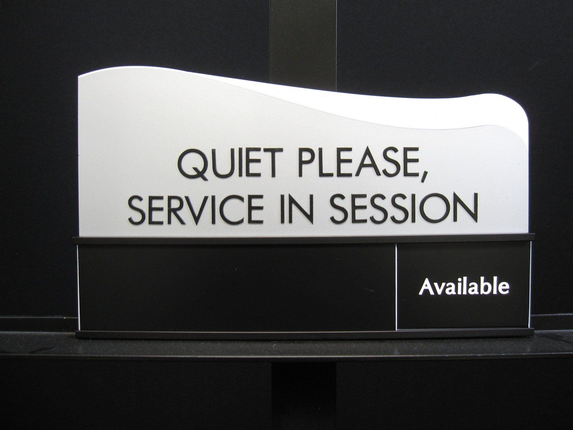 A sign that says quiet please service in session