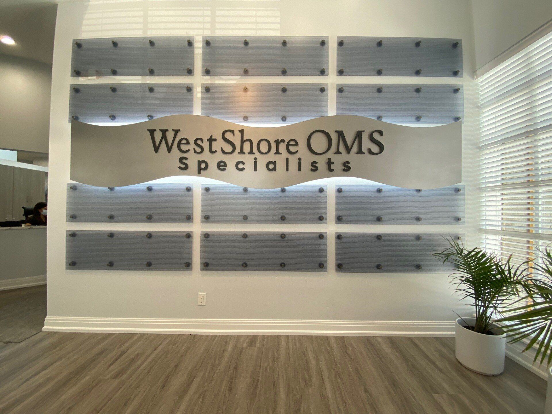 There is a sign on the wall that says west shore oms specialists.