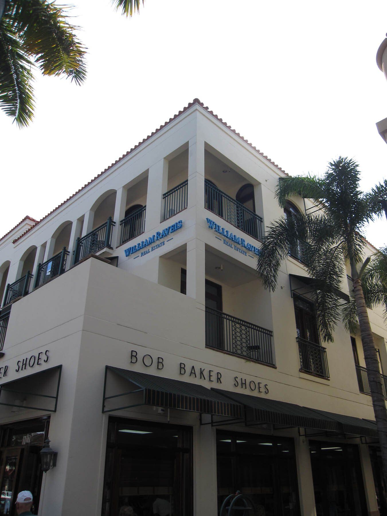 A white building with a sign that says bob baker shoes